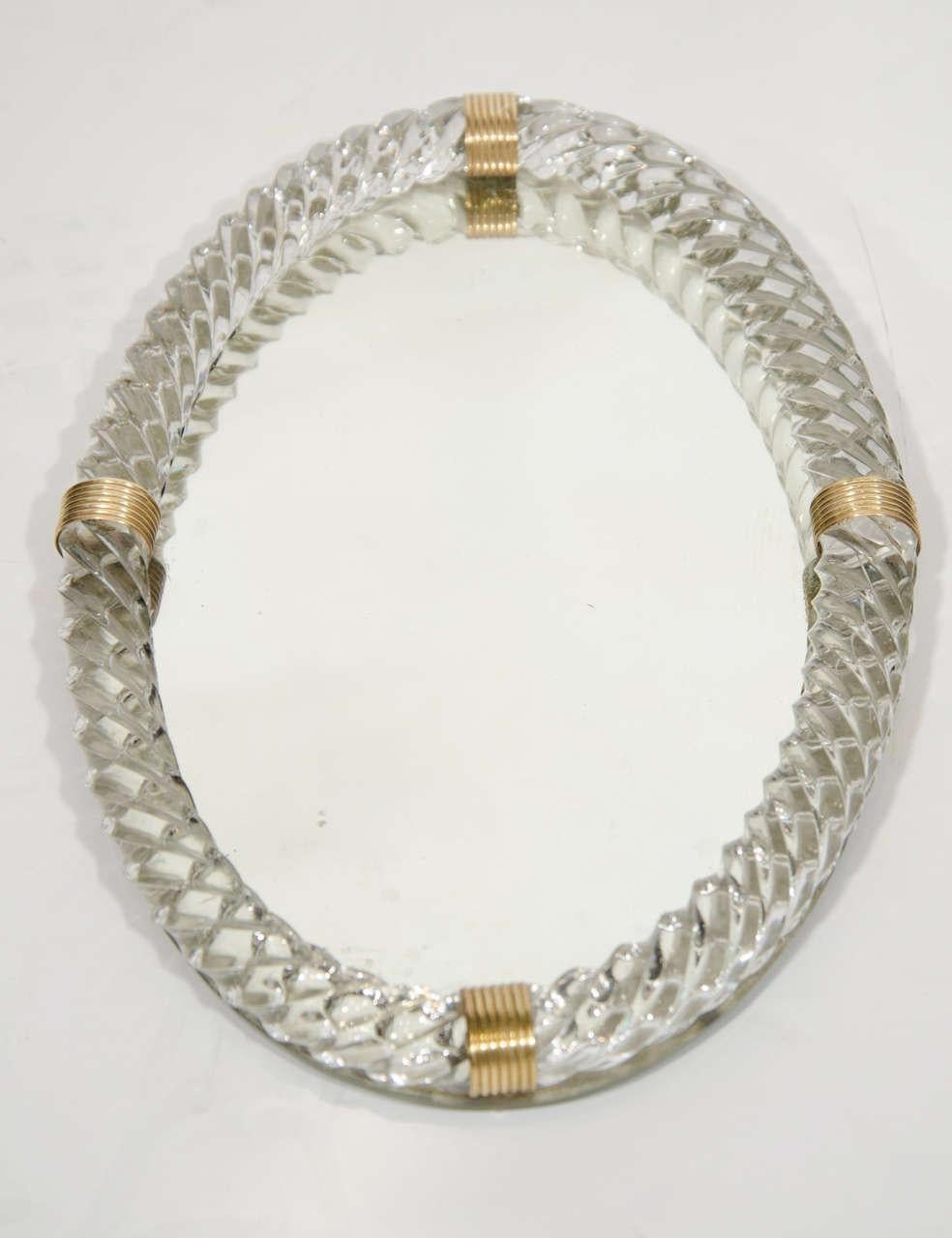 Exquisite Art Deco era mirrored tray with large hand blown Murano glass gallery in the form of twisted rope. The tray has an elegant oval form and features four bronzed metal fittings. Perfect as a vanity or commode accessory, or as a barware tray.