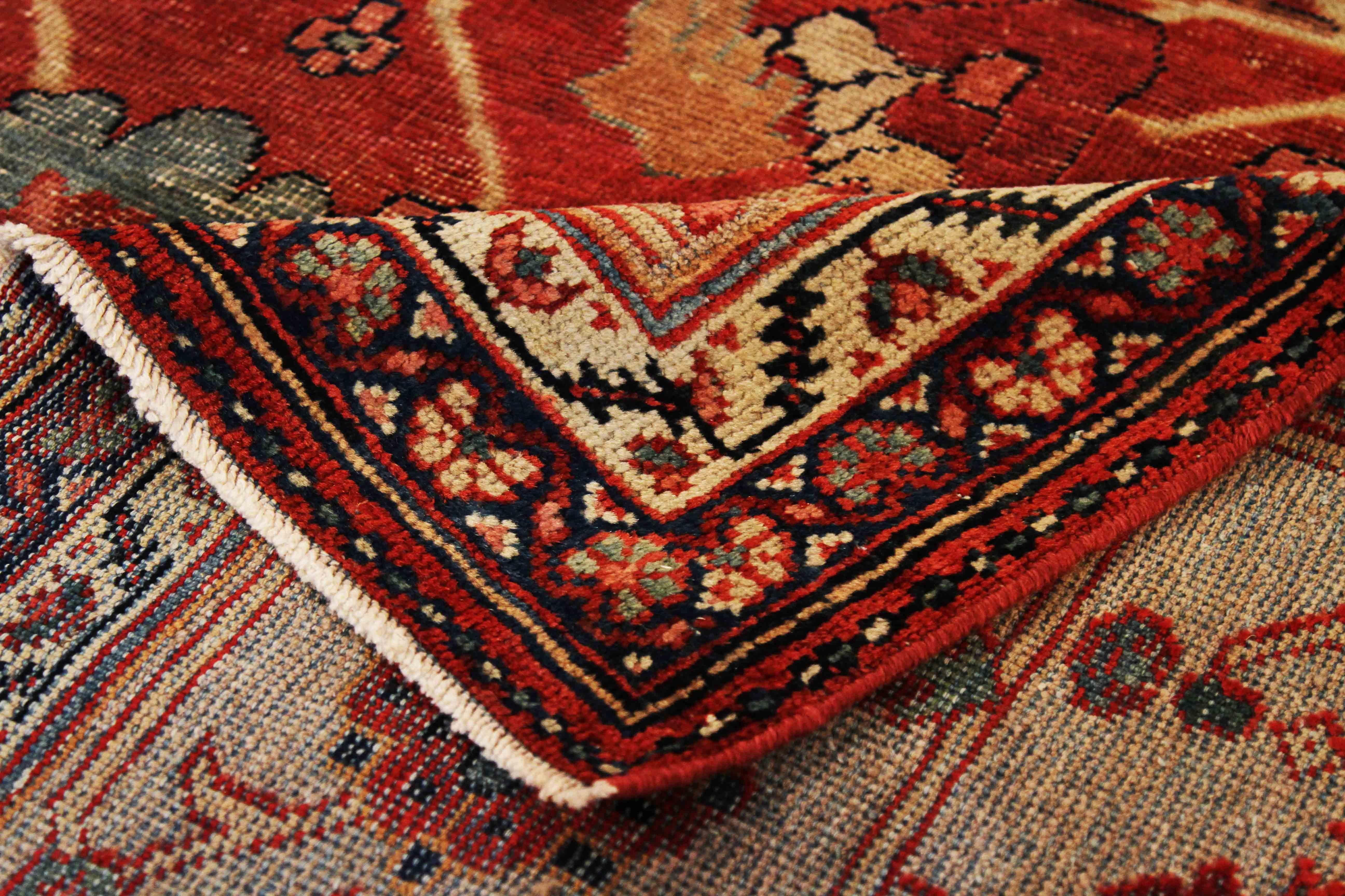 Handmade in the 1940s using the finest quality of wool and vegetable dyes. It’s an antique Persian rug woven with design patterns mastered by Sultanabad weavers. It features a powerful mix of red, black and green floral details which matches nicely