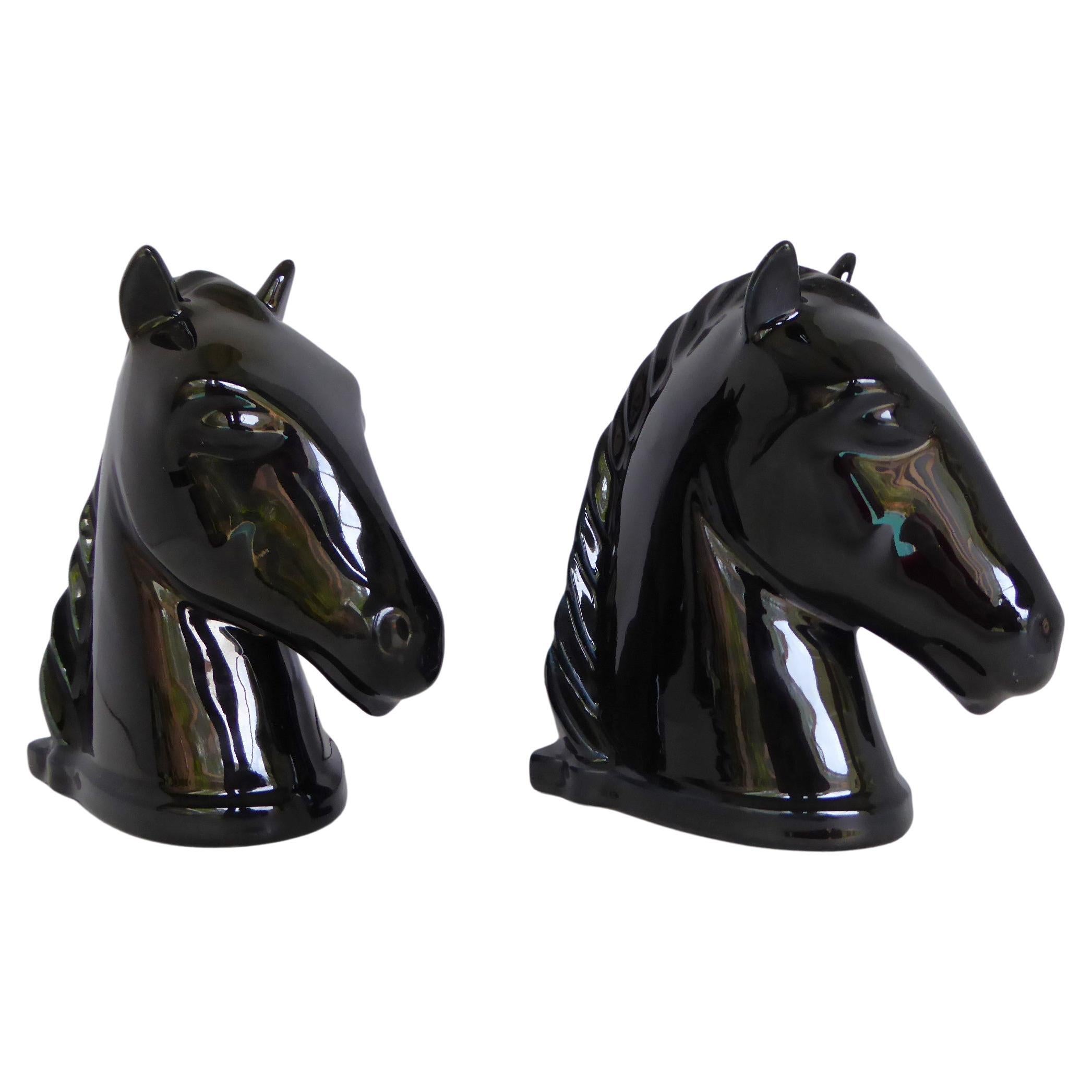 Handsome Pair of Mid Century Horse Head Modern Bookends by Abingdon Potteries.   Beautiful designed horse heads bookends in glossy black glaze which were produced from 1938 through 1950. Stamped on bottom in ink with the ABINGDON USA  in a rectangle