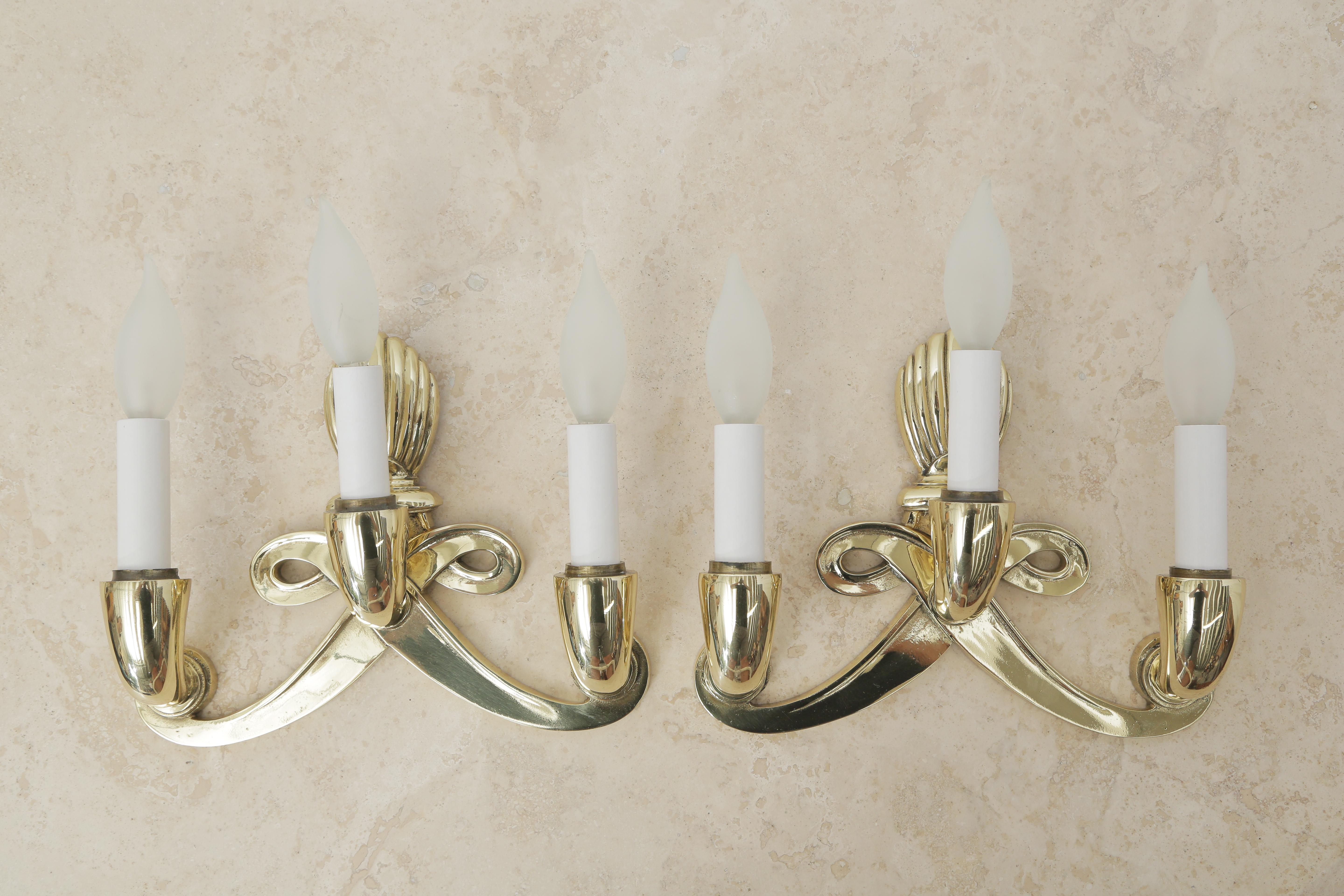 Pair of polished brass sconces circa 1940 in the style of French Designer Jules Leleu.
Recently re-wired for the US, the metal has been polished. Classical design from the 1940s and typical style from French designer Jules Leleu for most of his