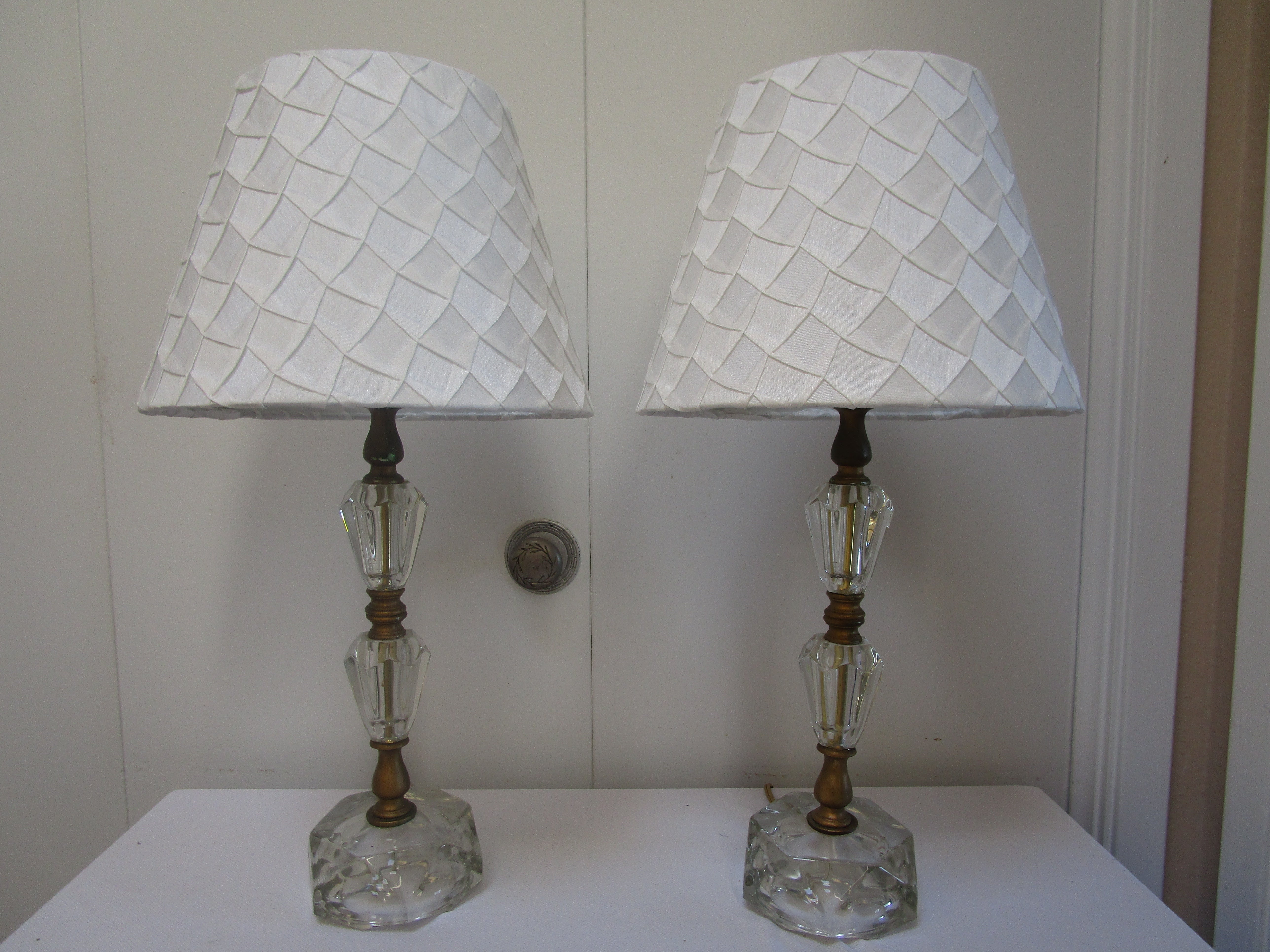 Beautiful art deco touches to faceted, polished crystal glass pair of table lamps makes for statement lighting. 
These are the most alluring table lamps for a console table or a bedroom. The geometric facets continue to the base and give the lamps
