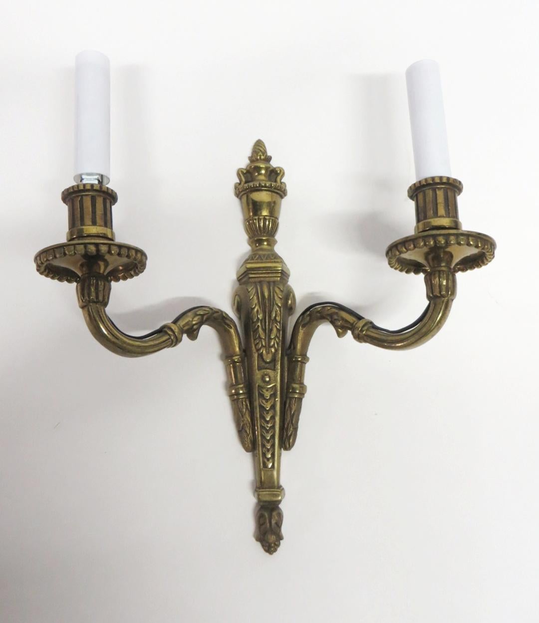 Bronze two arm candlestick sconces with an antique bronze patina from the 1940s. Priced as a pair. This can be seen at our 400 Gilligan St location in Scranton, PA.