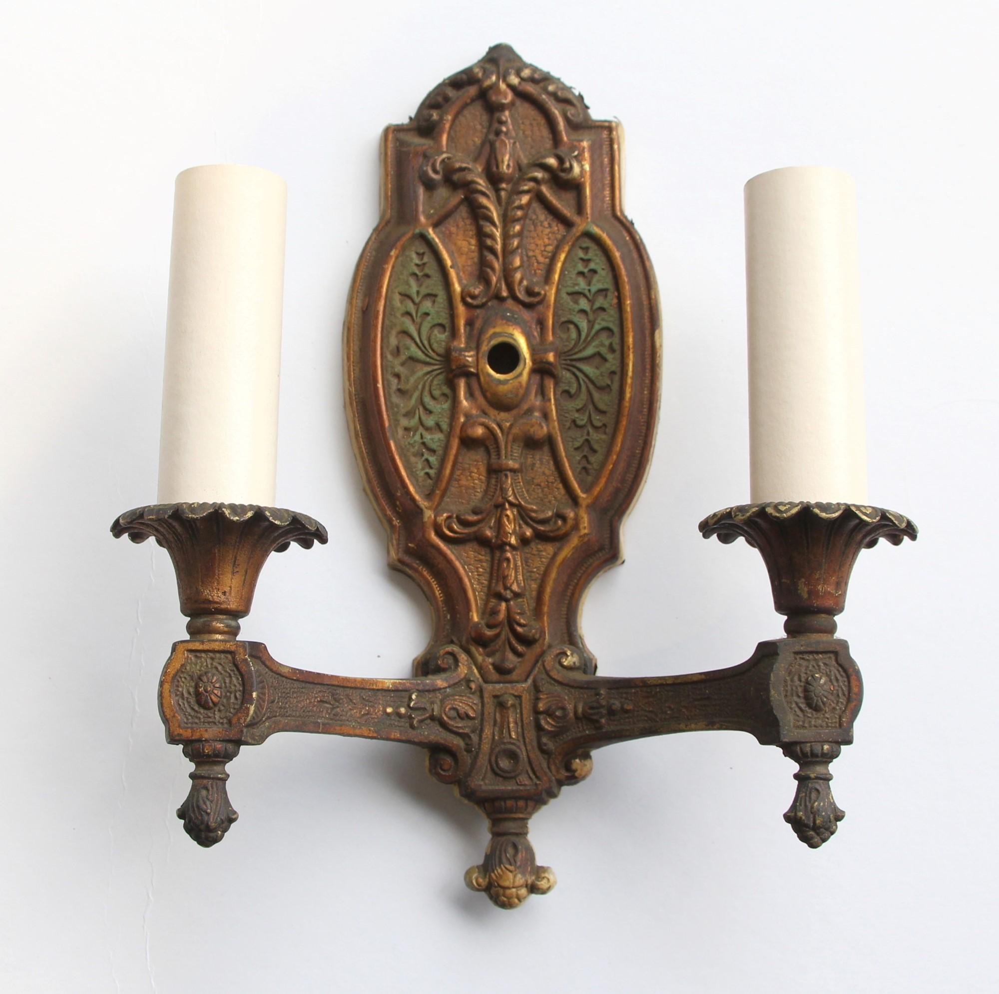 Pair of Gothic double arm sconces with original green and gold bronze finish. From the 1940s. These will be cleaned and rewired before shipping. Priced as a pair. This can be seen at our 400 Gilligan St location in Scranton, PA.