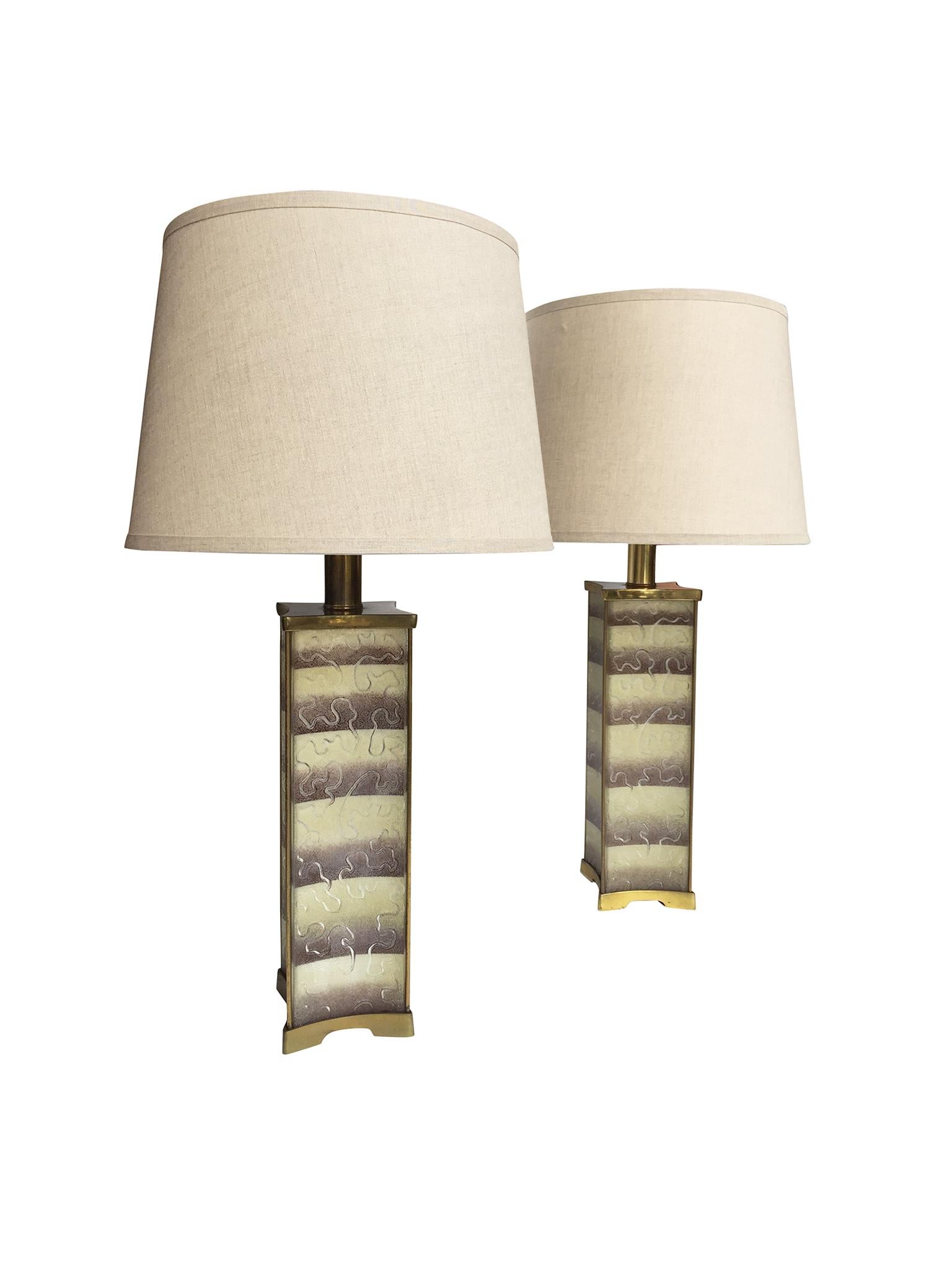 These elegant table lamps were manufactured by Lightolier in the 1940s. They are incredibly detailed in their design and are comprised of a brass frame, base, and hardware, frosted glass inserts, a mirrored interior, and glass diffusers. The frosted