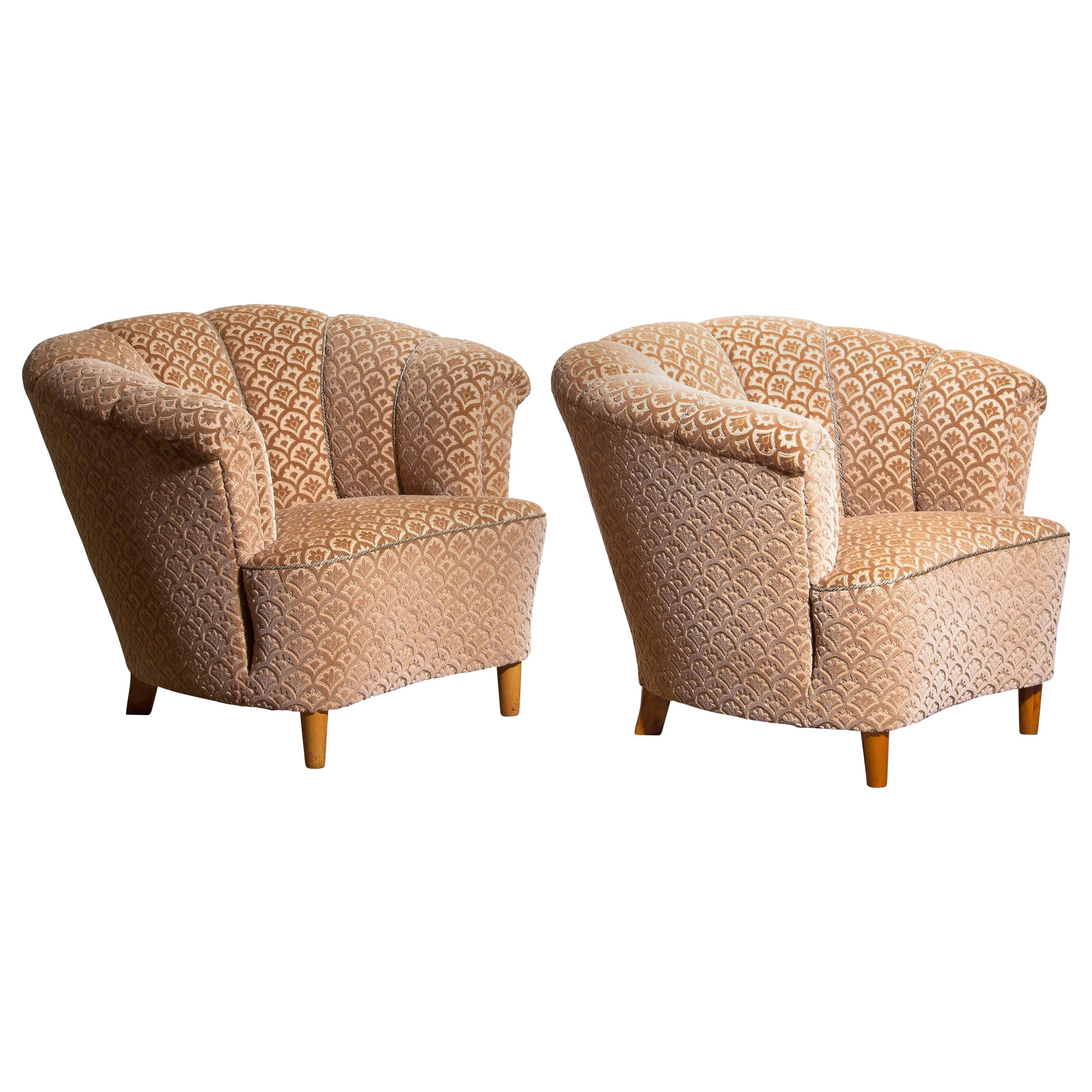 Beautiful set of two comfortable club lounge cocktail chairs from the 1940s.
Both chairs are in original and excellent condition.
The chairs are richly upholstered in flocked velvet and standing on beech legs.
    