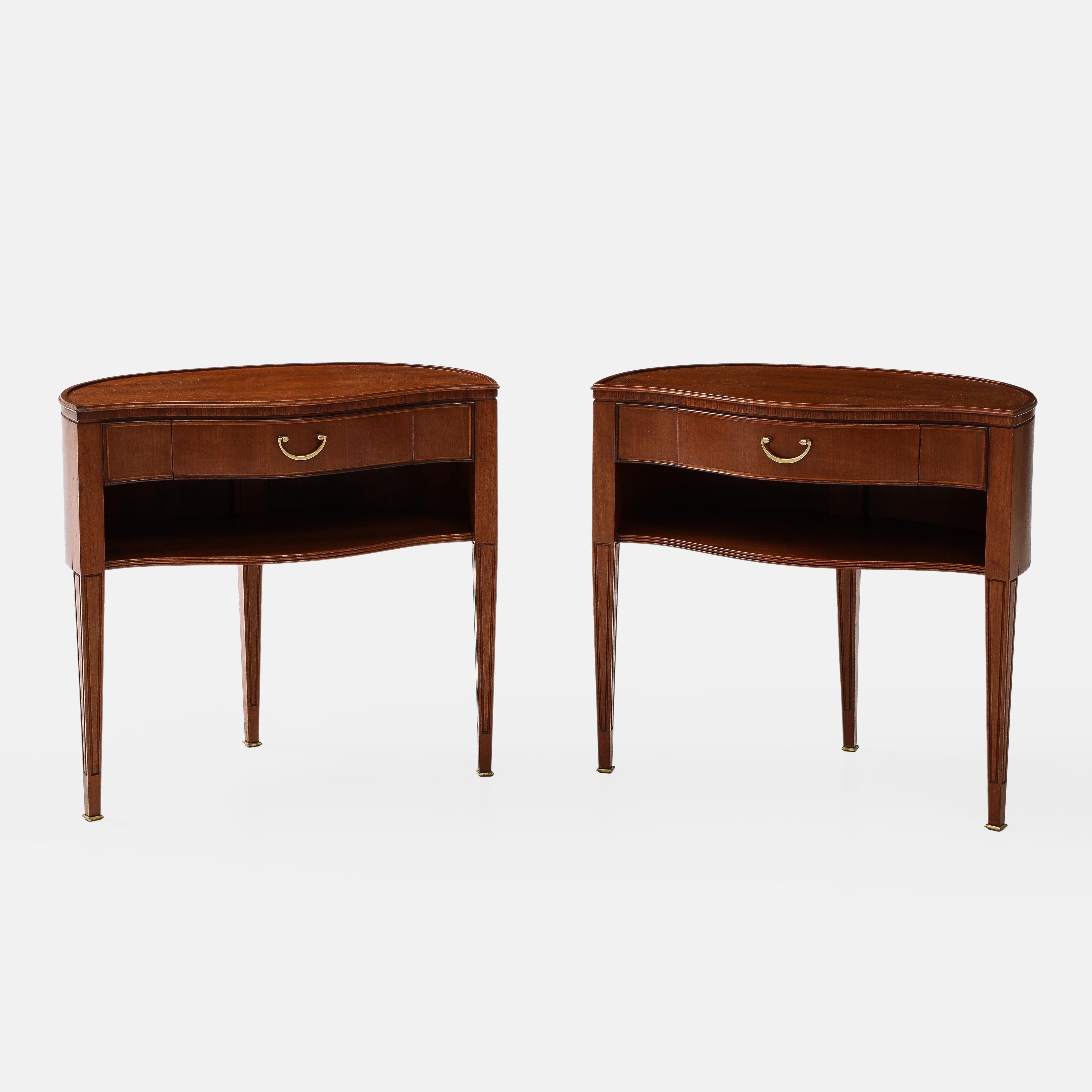1950s Paolo Buffa pair of polished mahogany nightstands or bedside tables with three tapering legs ending in brass sabots.  These elegant nightstands have a lovely curvaceous front and demilune shaped back and each hold a single drawer with an open