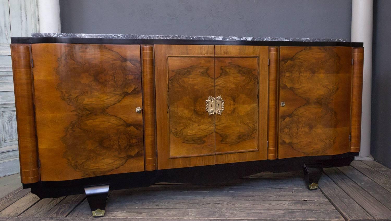 French 1940s walnut veneered sideboard with original grey-veined marble. All hardware is original to piece. Recently polished. This is a very unusual piece that came from a Parisian salon. The marble top in  the photos  was recently broken and