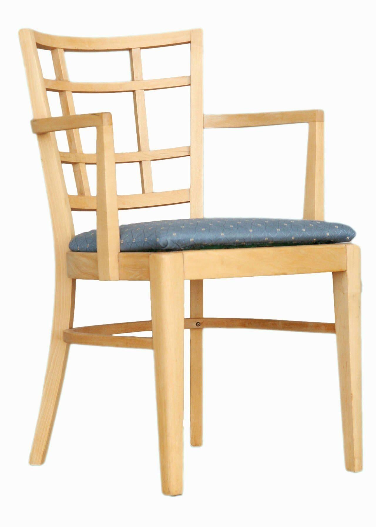 Set of lattice-back dining chairs by Paul Frankl for Brown Saltman group. The chairs upholstered in high quality blue cotton fabric. The set includes seven captain's chairs.

North America, circa 1940.