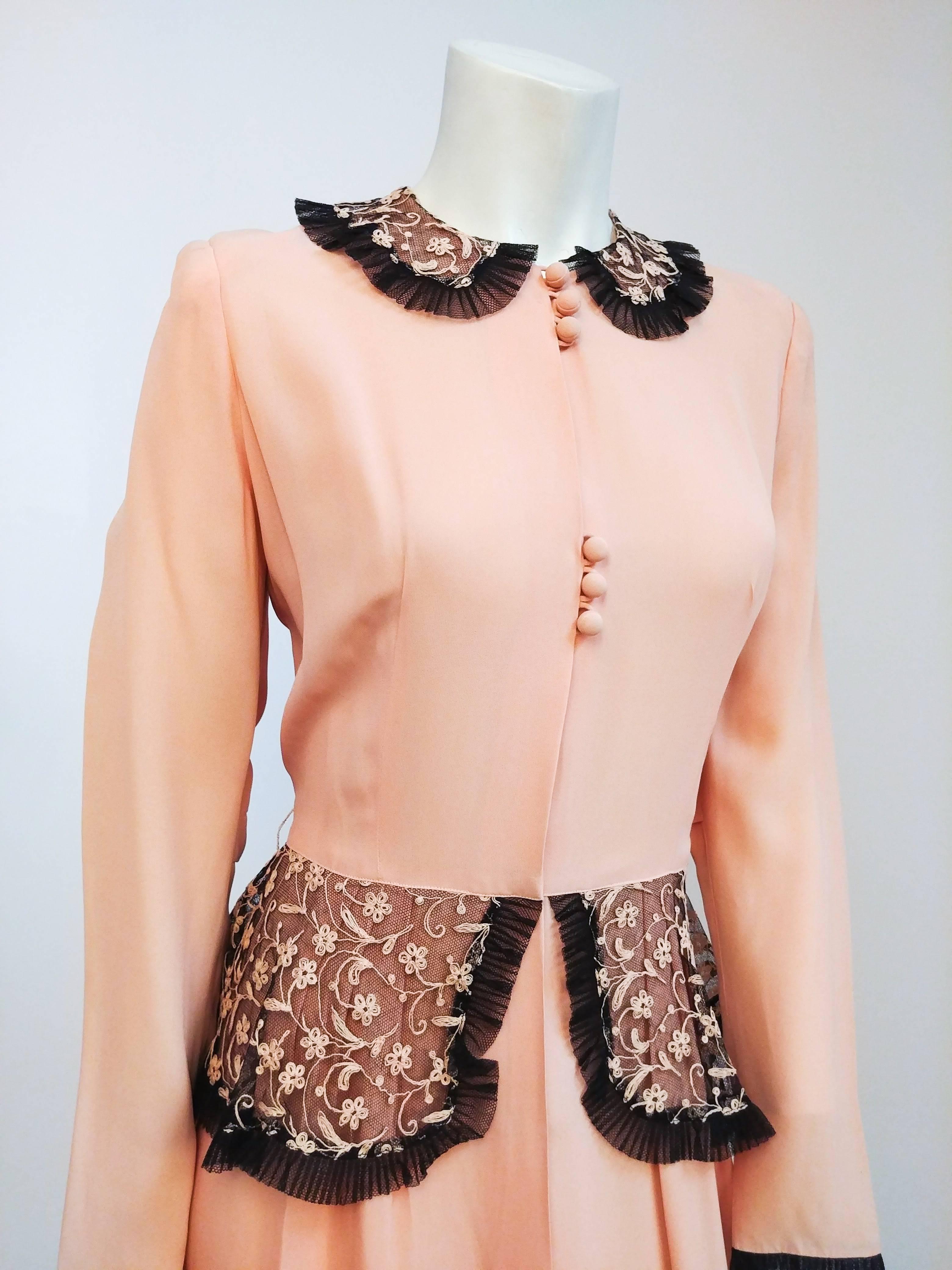 1940s Petal Pink Black Lace Peplum Dress. Full-length 1940's evening dress with embroidered lace collar, cuffs, and peplum. Button-front closure. Magazine with original advertisement included.