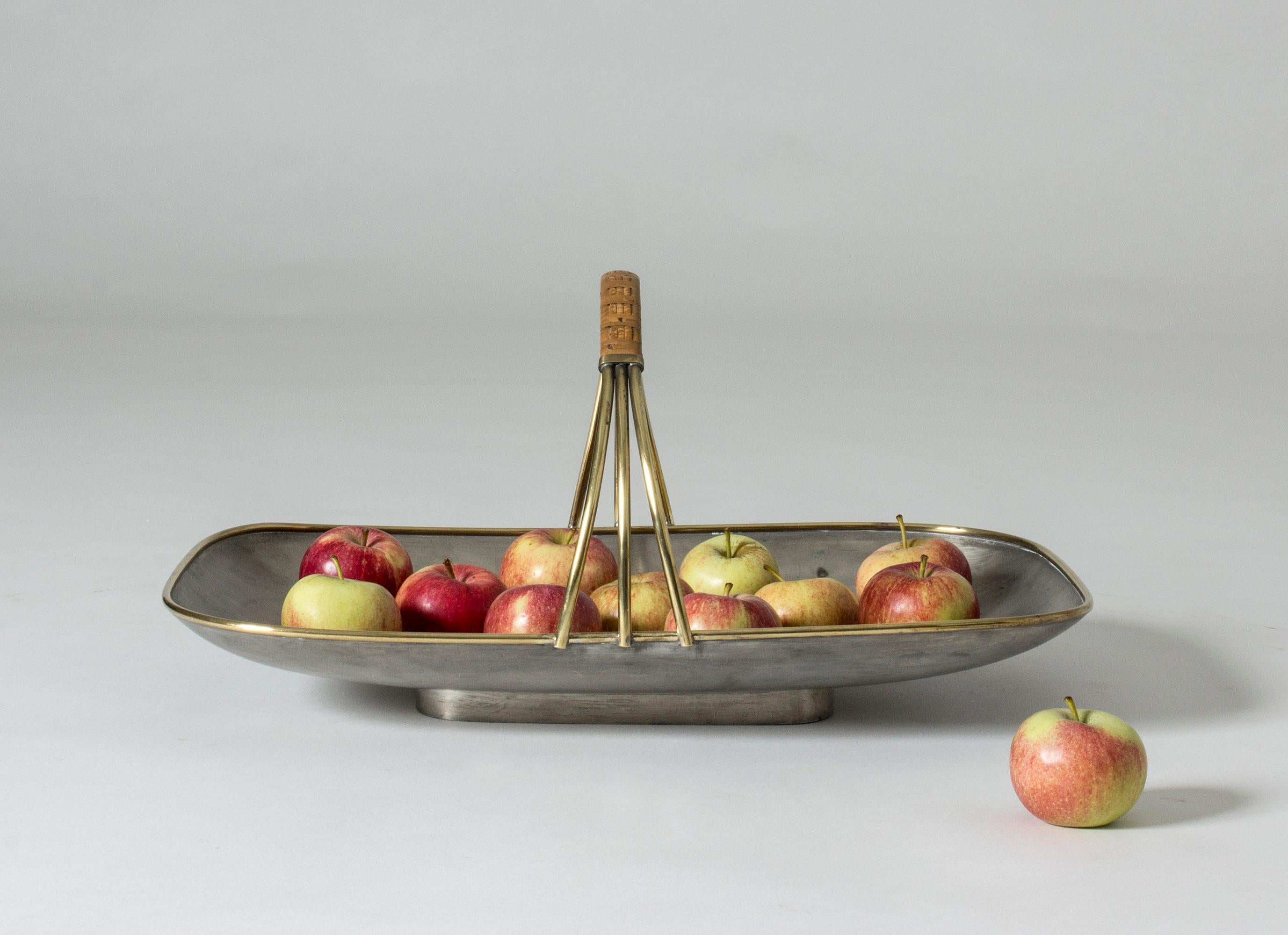 Beautiful, large pewter tray by Nils Fougstedt. Elegant brass rim and handle with wreathed rattan.