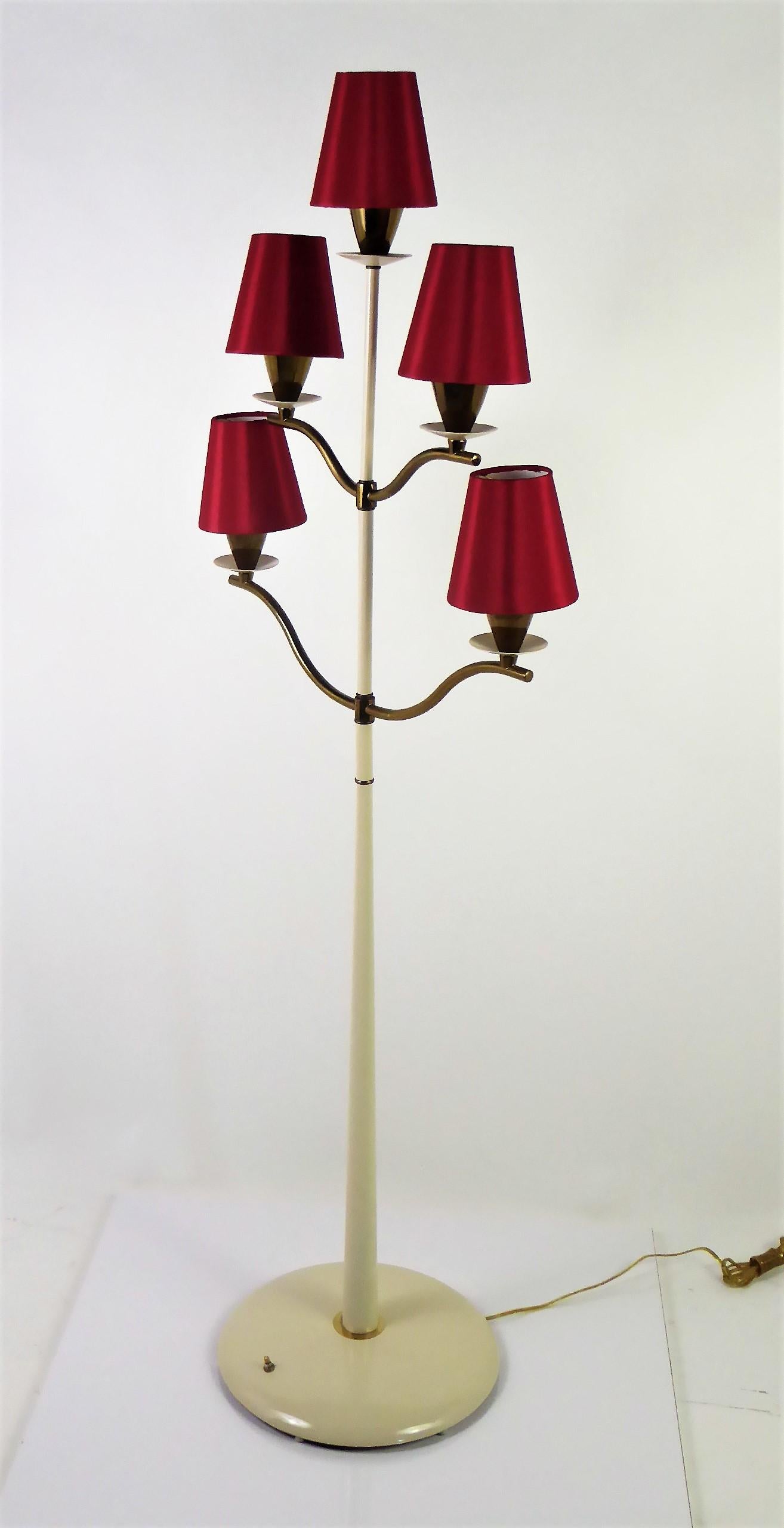 1940s elegant five-light candelabra floor lamp in the style of Pietro Chiesa. With dark brass arms and trims with a creamy white base and rising pole supporting the arms. Newly rewired and has foot switch on base, controlling variable on/offs. New