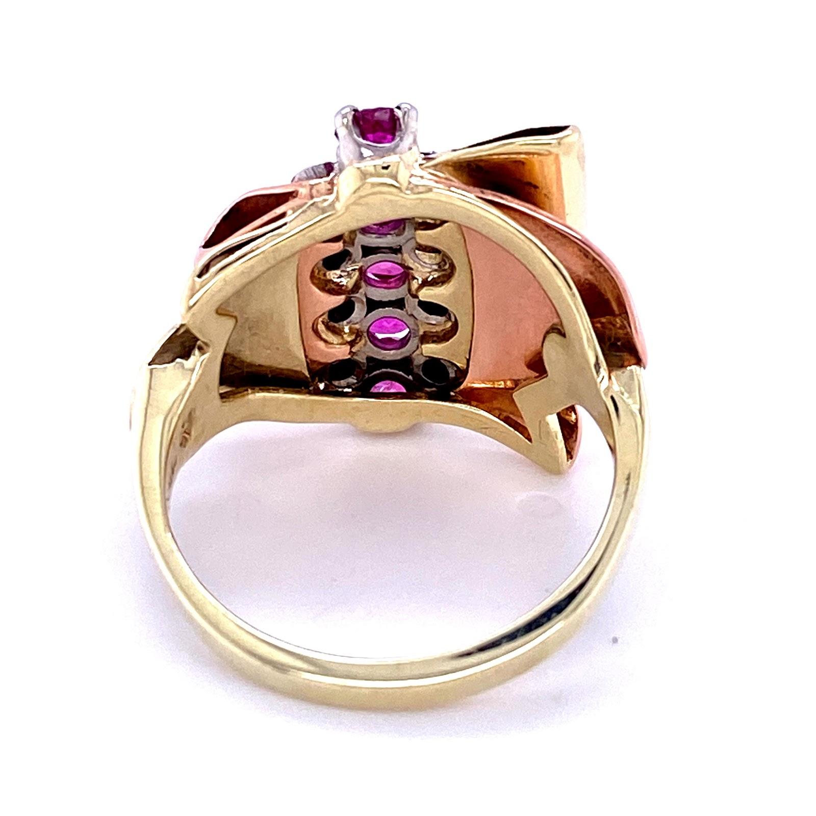 14 karat rose gold, green gold, and palladium ring with a ribbon design. Set with 5 round pink sapphires measuring 3.2 mm each, adn 8 single cut diamonds measuring 0.10 carat total diamond weight in the I - J color range, SI clarity range. The ring