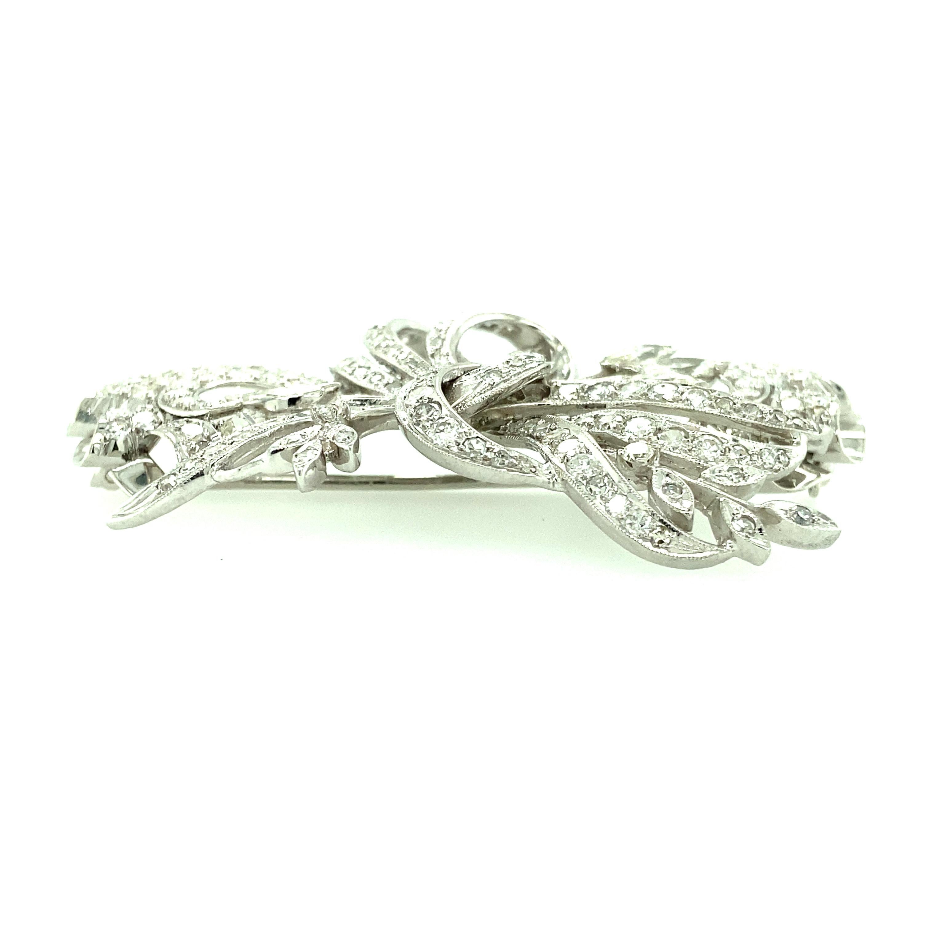 One platinum estate diamond brooch set with one hundred fifty-six brilliant cut diamonds 4.25 carat total weight with matching H/I color and SI clarity and four marquise cut diamonds 1.10 carat total weight with matching H/I color and SI clarity. 