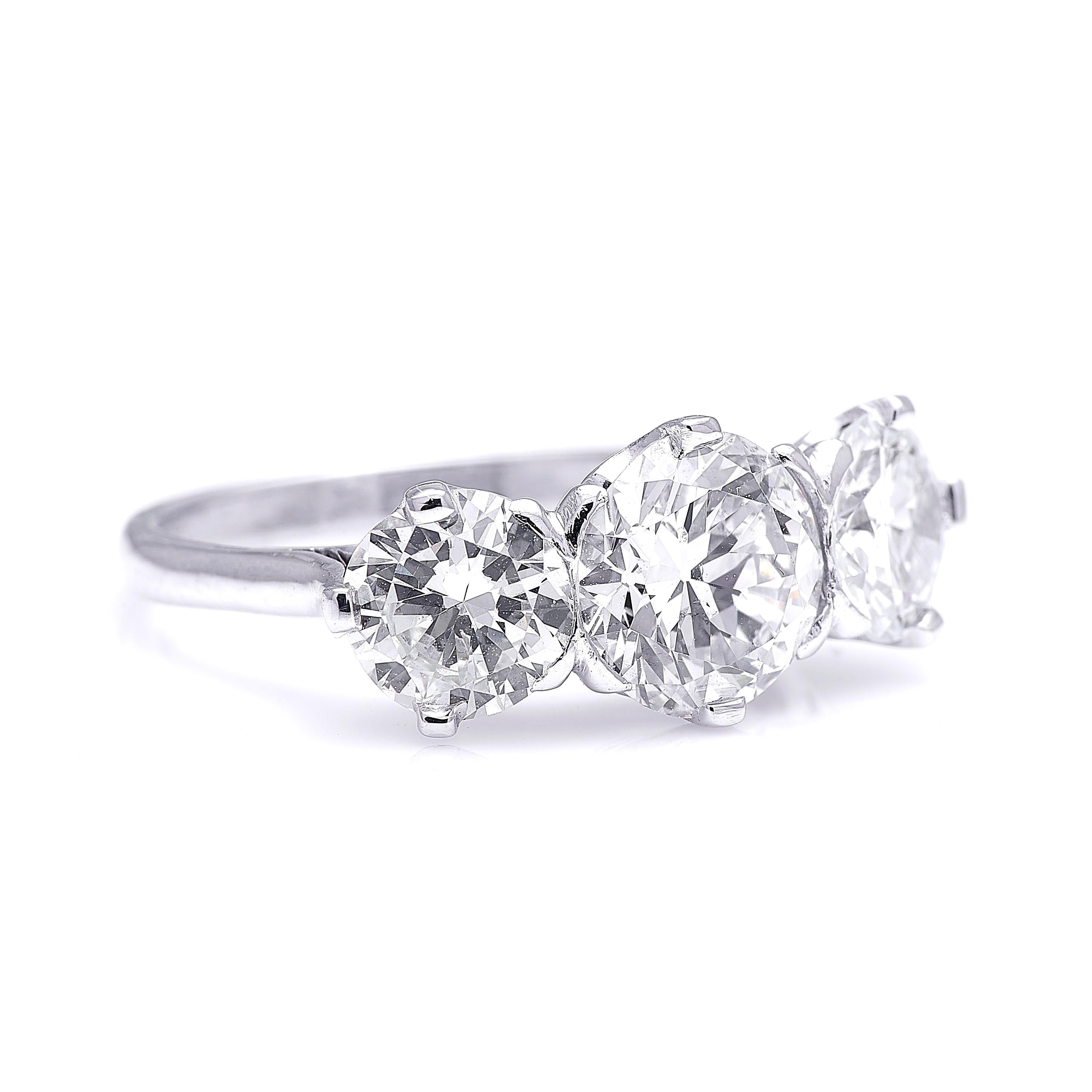 Diamond trilogy ring, mid 20th century. This classic three-stone diamond ring is set with a substantial trio of early to mid-20th century circular-cut diamonds. With a centre stone weighing approximately 1.40 carats, and shoulder stones each
