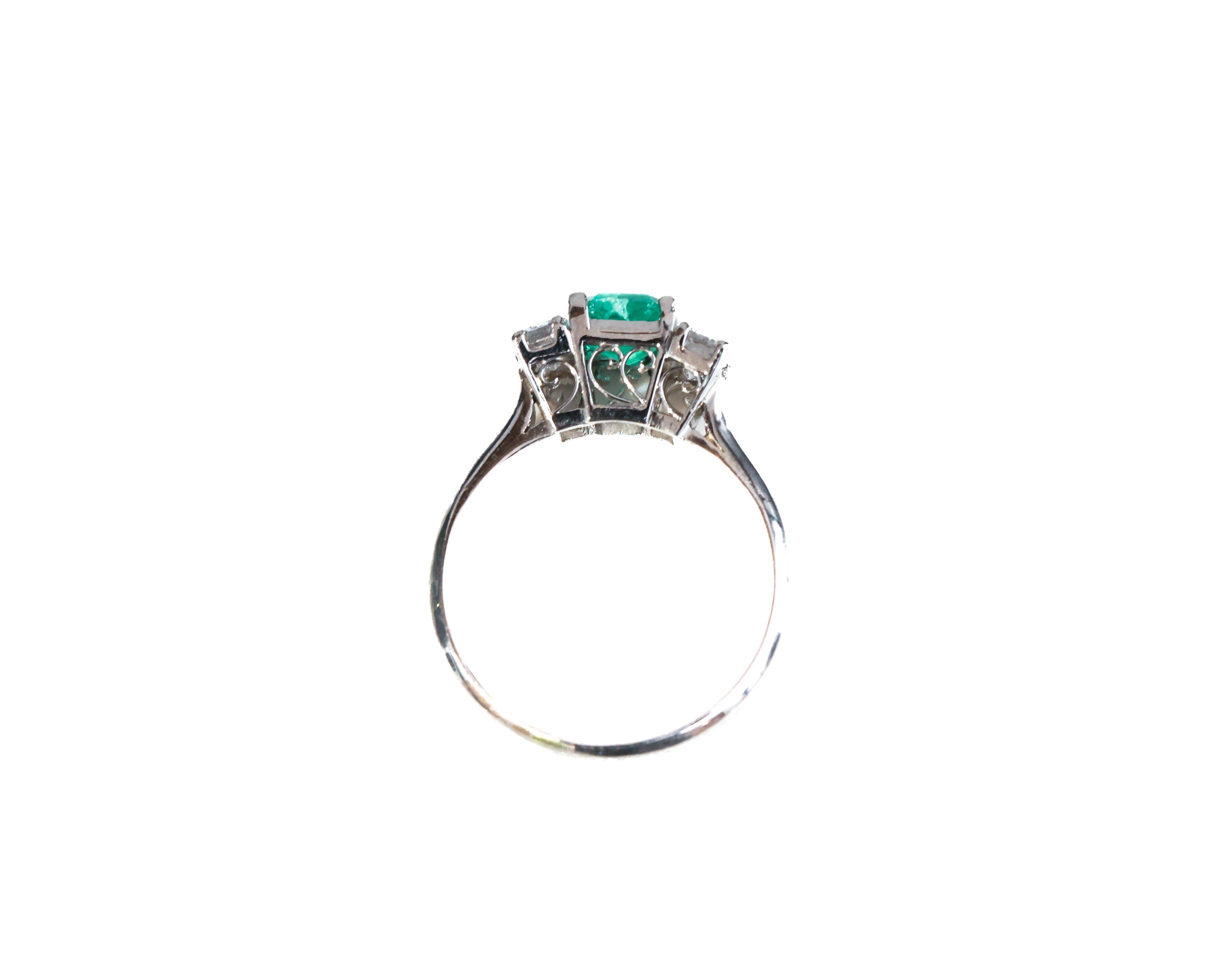 Ring Details:
Metal Type: Platinum
Weight: 3.5 grams
Ring Size: 5.5 (resizable)

Emerald Details:
Carat: .68 carat 
Color: Vibrant Green

Diamond Details:
Cut: Emerald Cut
Carat: .51 carat total weight 
Color: F
Clarity: VS

1940s Classic 3-Stone