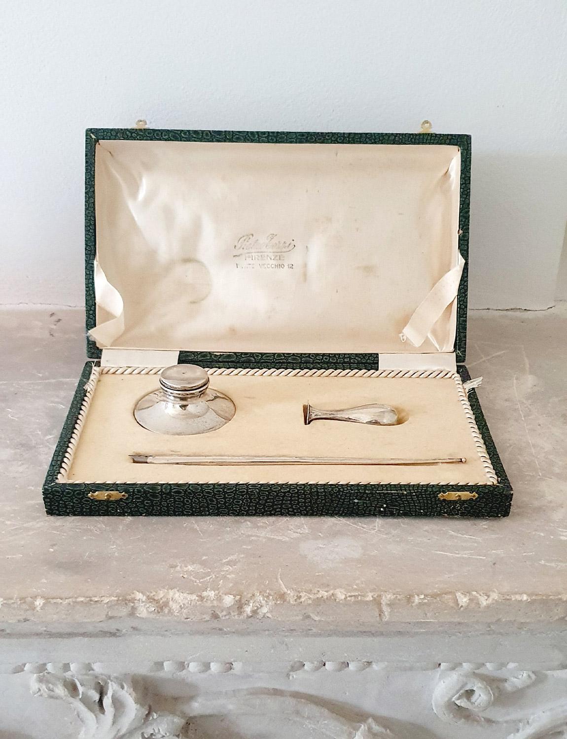 A hand crafted solid silver writing set originally sold by the silversmith, Rebbio Corri at number 12 Ponte Vecchio. The set consists of a silver inkwell (with minute glass inlay to hold ink), a fountain pen with removable nib and a silver stamp for