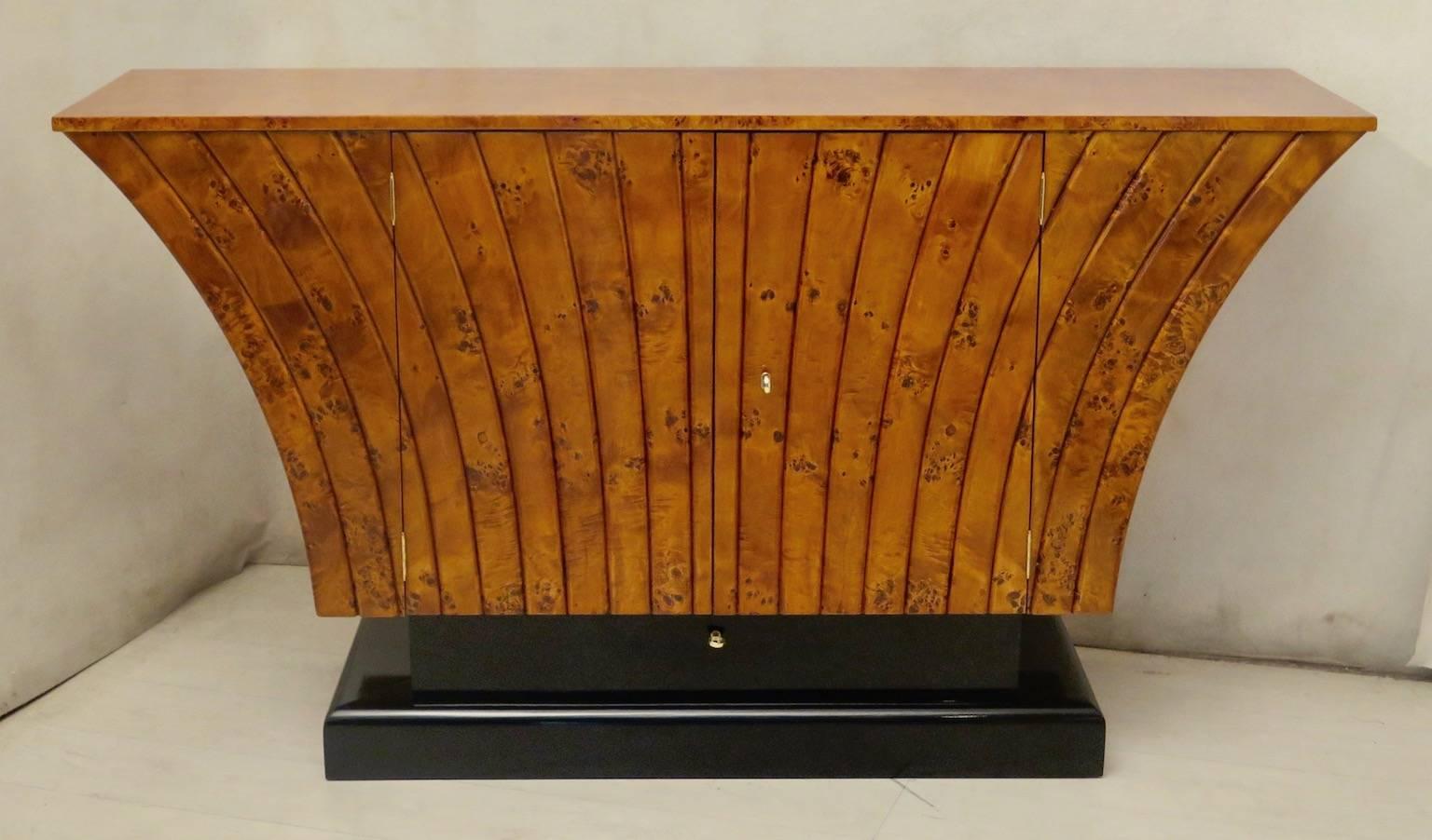 Italian Art Deco sideboard. All veneered in poplar wood. It is a very valuable wood root because it is full of knots. The top is rectangular squared, then a very particular body develops below. A series of wooden ribs develop from bottom to top, as