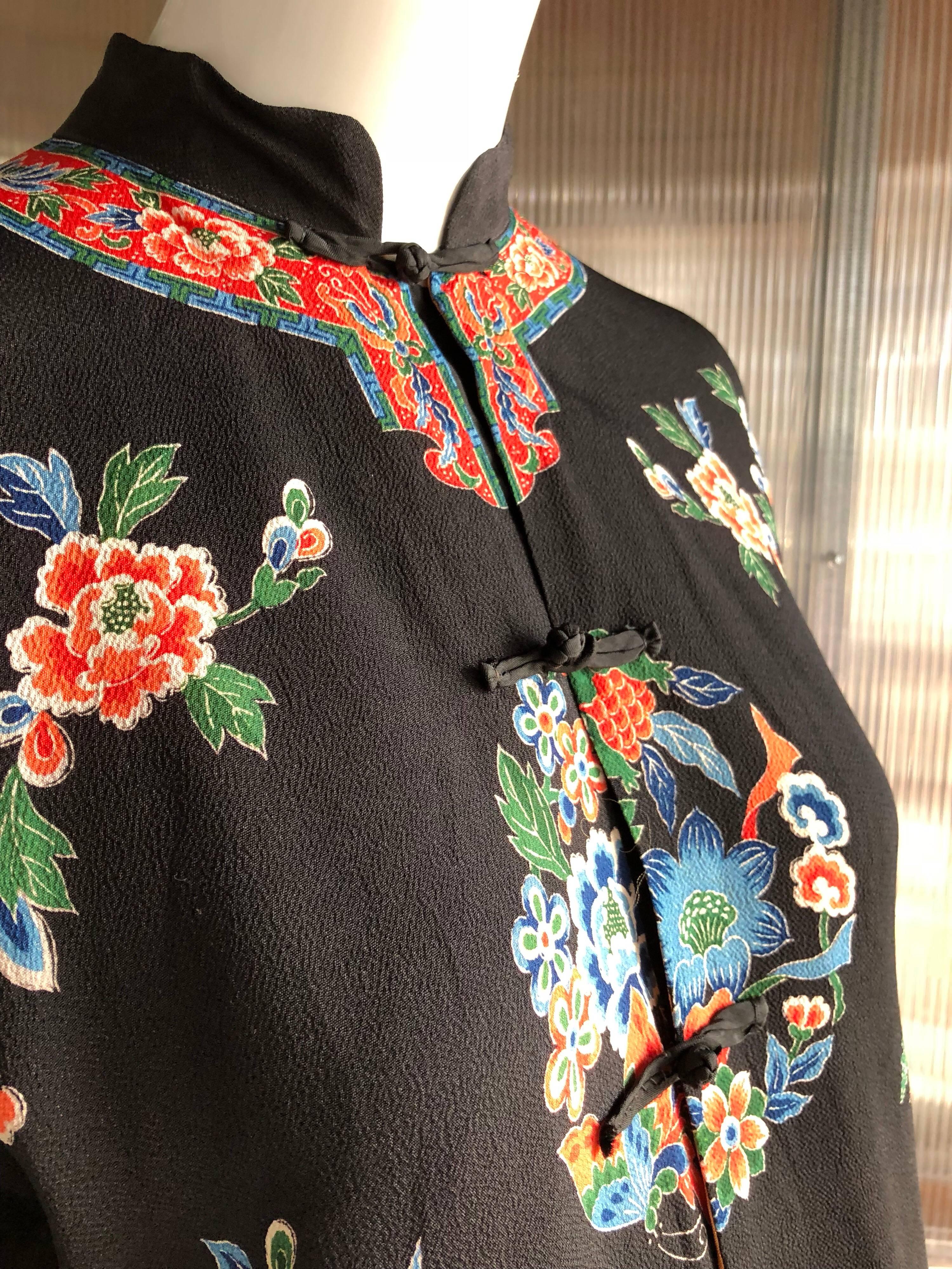 1940s Printed silk and rayon blend bed jacket with Nehru collar, frog closures and flared sleeves.  Printed to replicate the traditional embroidered Chinese Art Deco period style. Lined in silk. 