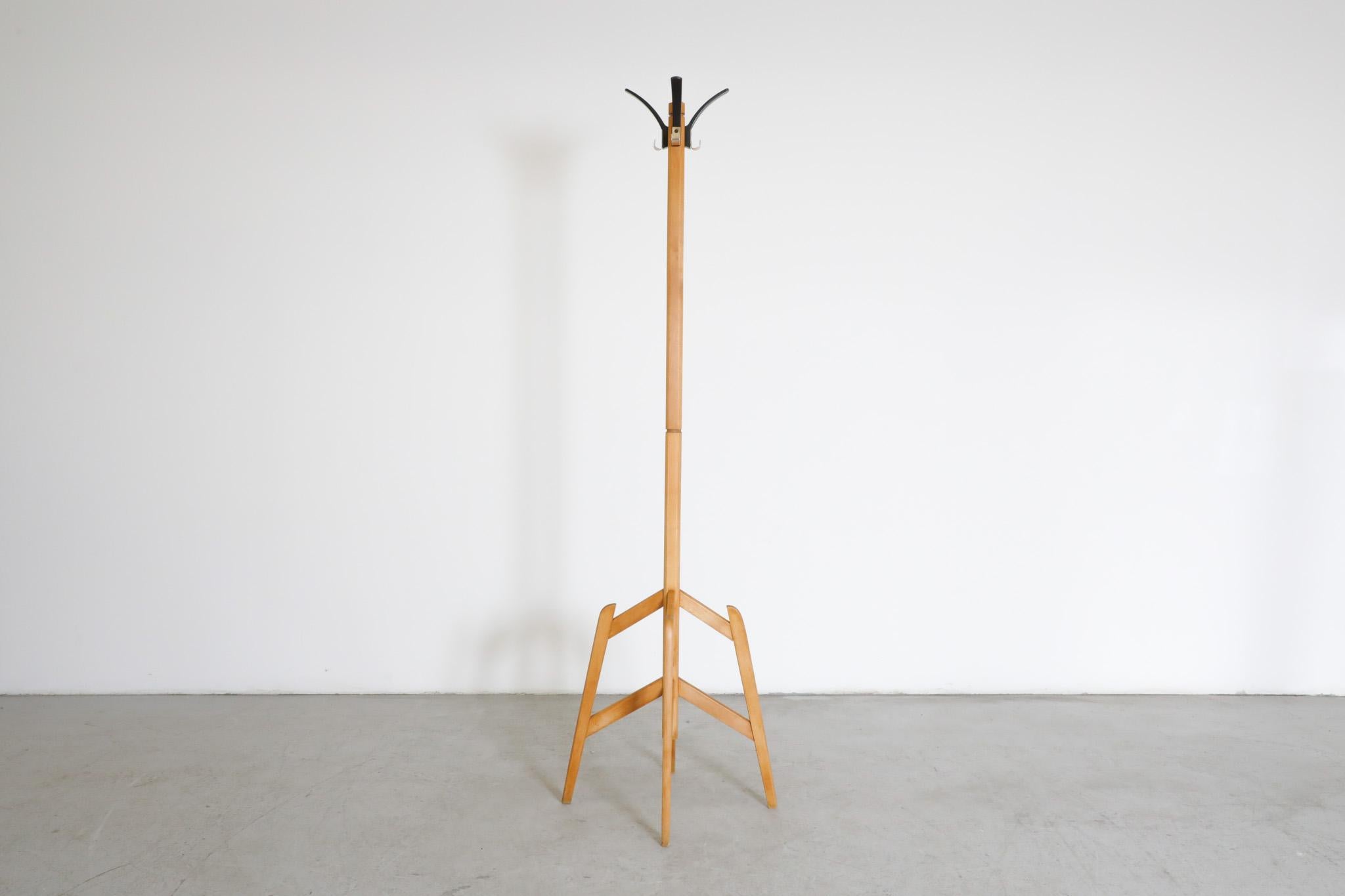 Gorgeoius, minimalistic, 1940's wooden standing coat tree with black coat hooks. Beautiful, simple Prouve inspired design, stripped to its essence without compromising its esthetics nor function. In original condition with visible wear consistent