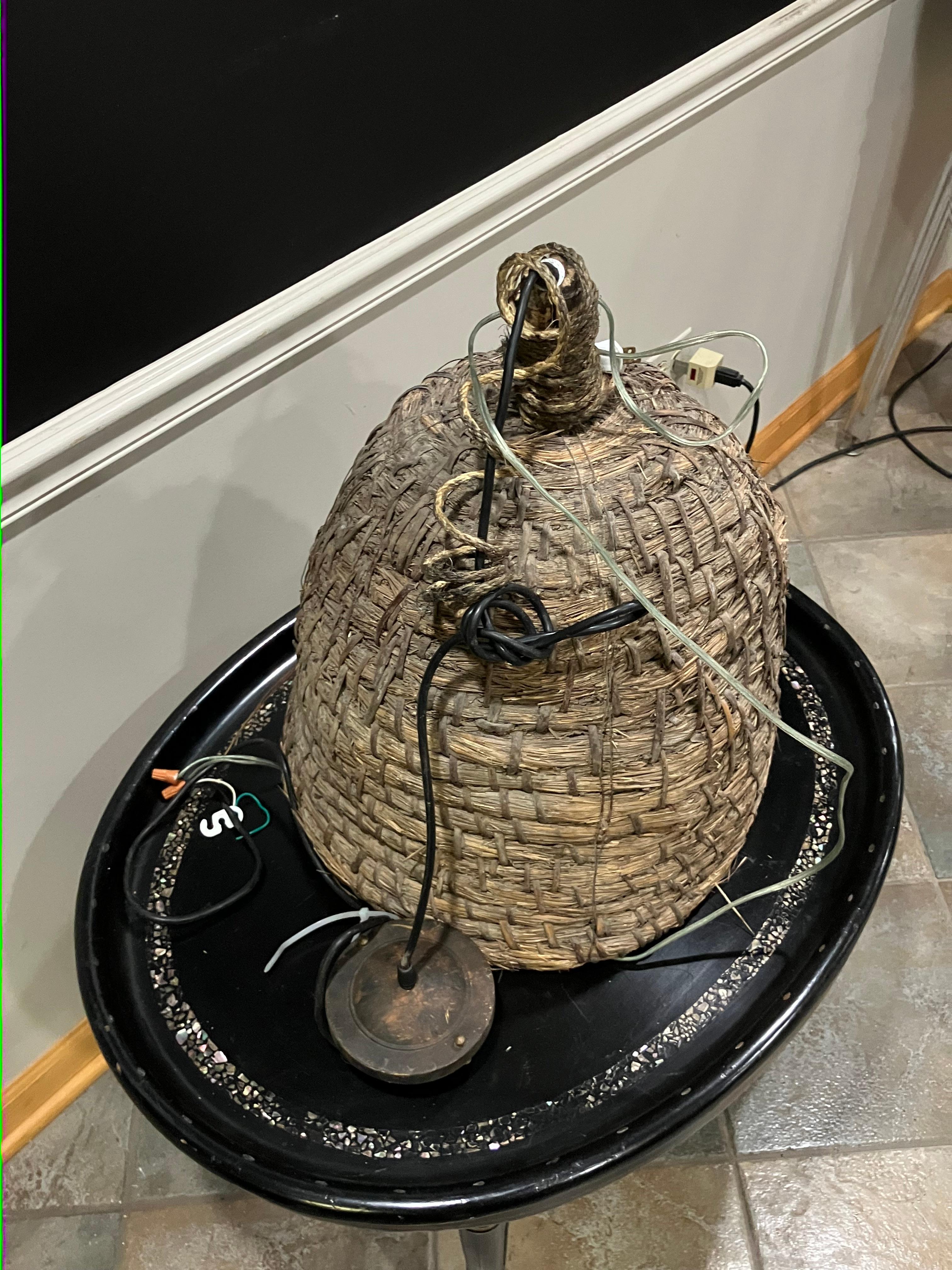 Woven basket chandelier originating from the Pyrenees region, circa 1940s. Constructed from natural fiber in a tightly coiled weave. Recently rewired and in working condition. The form and texture lend the piece an organic, rustic presence, suitable