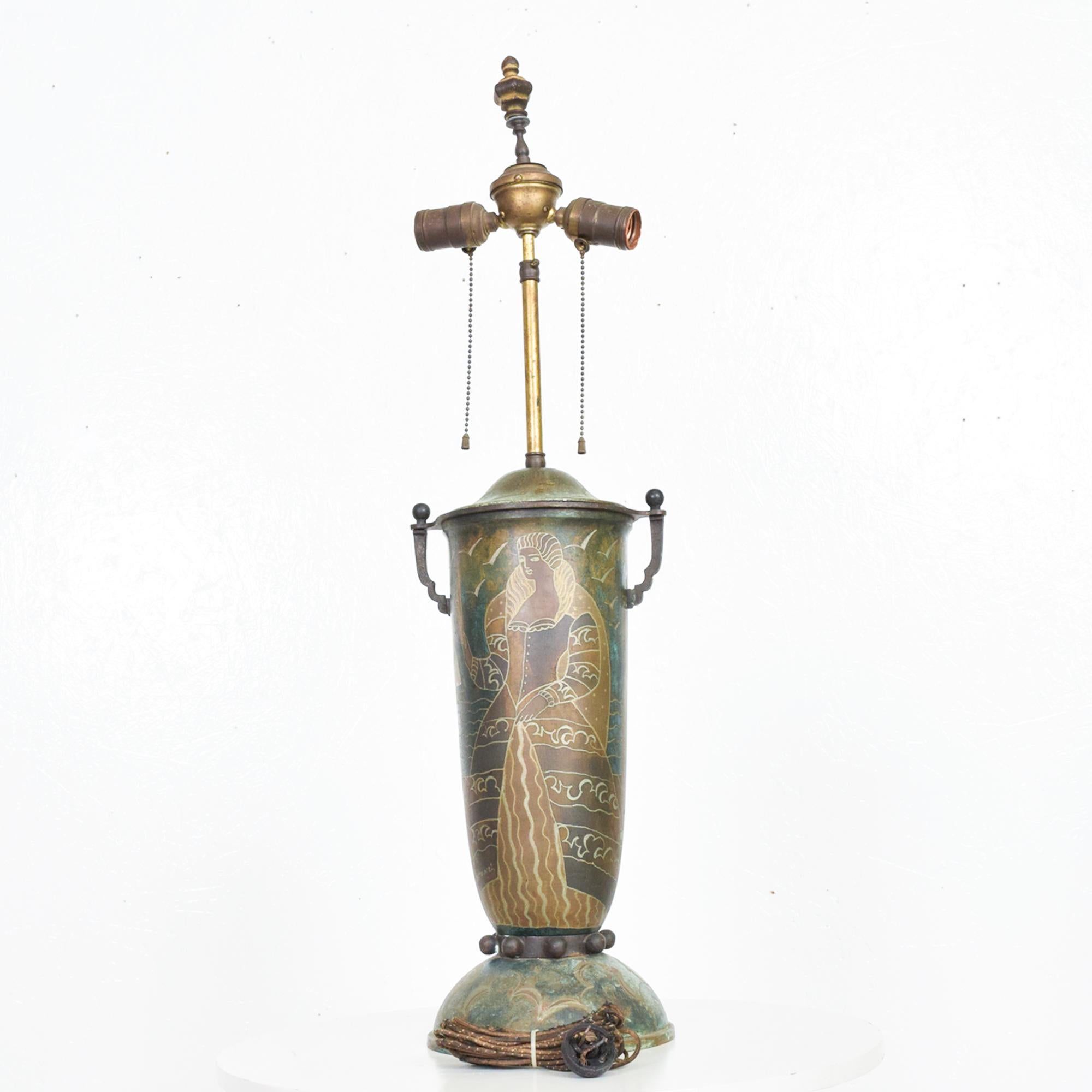 Exceptional French Art Deco urn table lamp Dinanderie technique.
French Dinanderie employs a use of mixed metals with an acid-etch technique for design.
Signed M Poincet stamped made in France, circa 1920s.
Features exceptional metal design