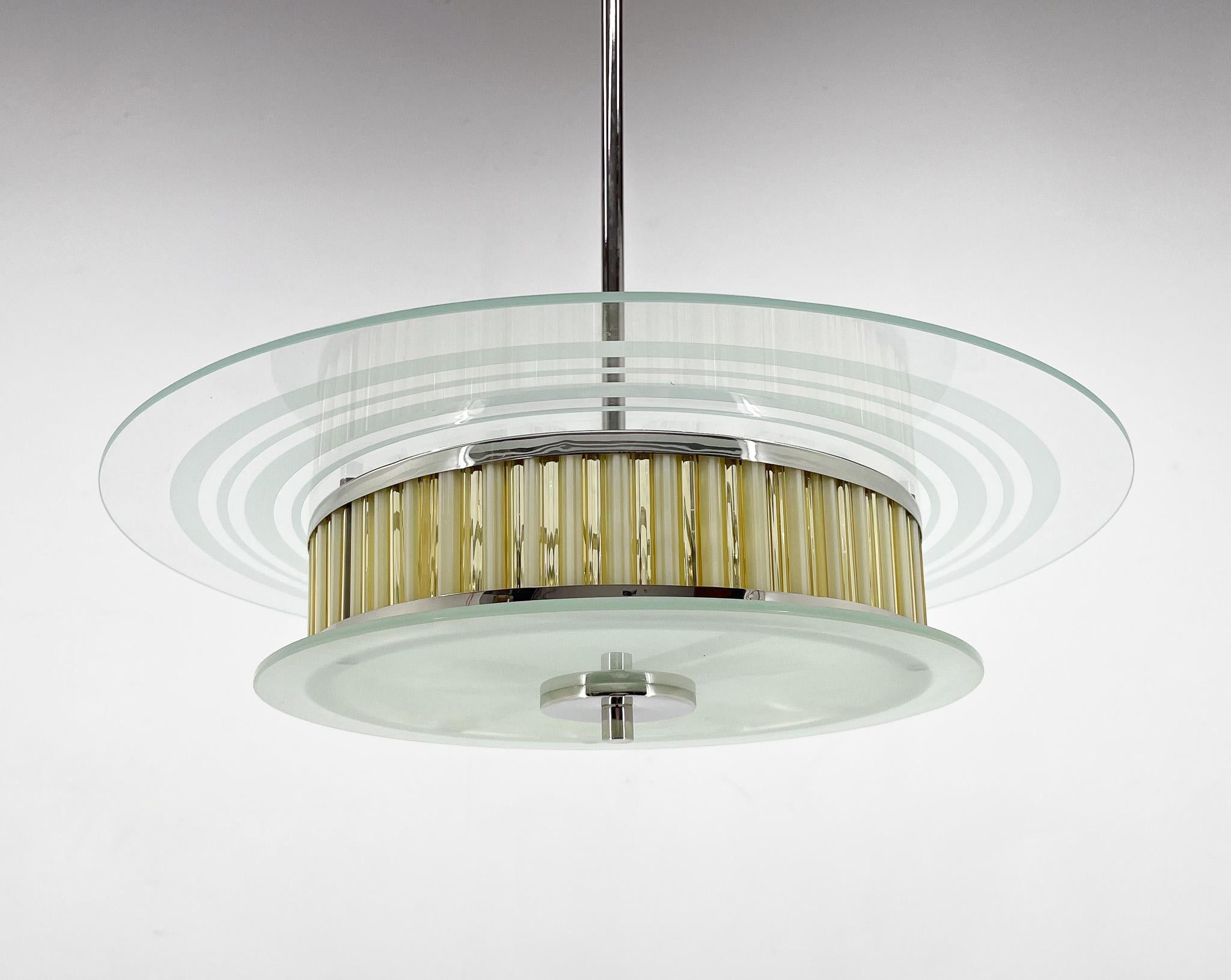 Beatiful, compleately restored rare chandelier made of chrome and glass. Manufactured in Italy in the 1950s. Matching wall lamps are available. Very good condition (see photo) restored, rewired. 
Bulbs: 3 x E26-E27. 
US wiring compatible.