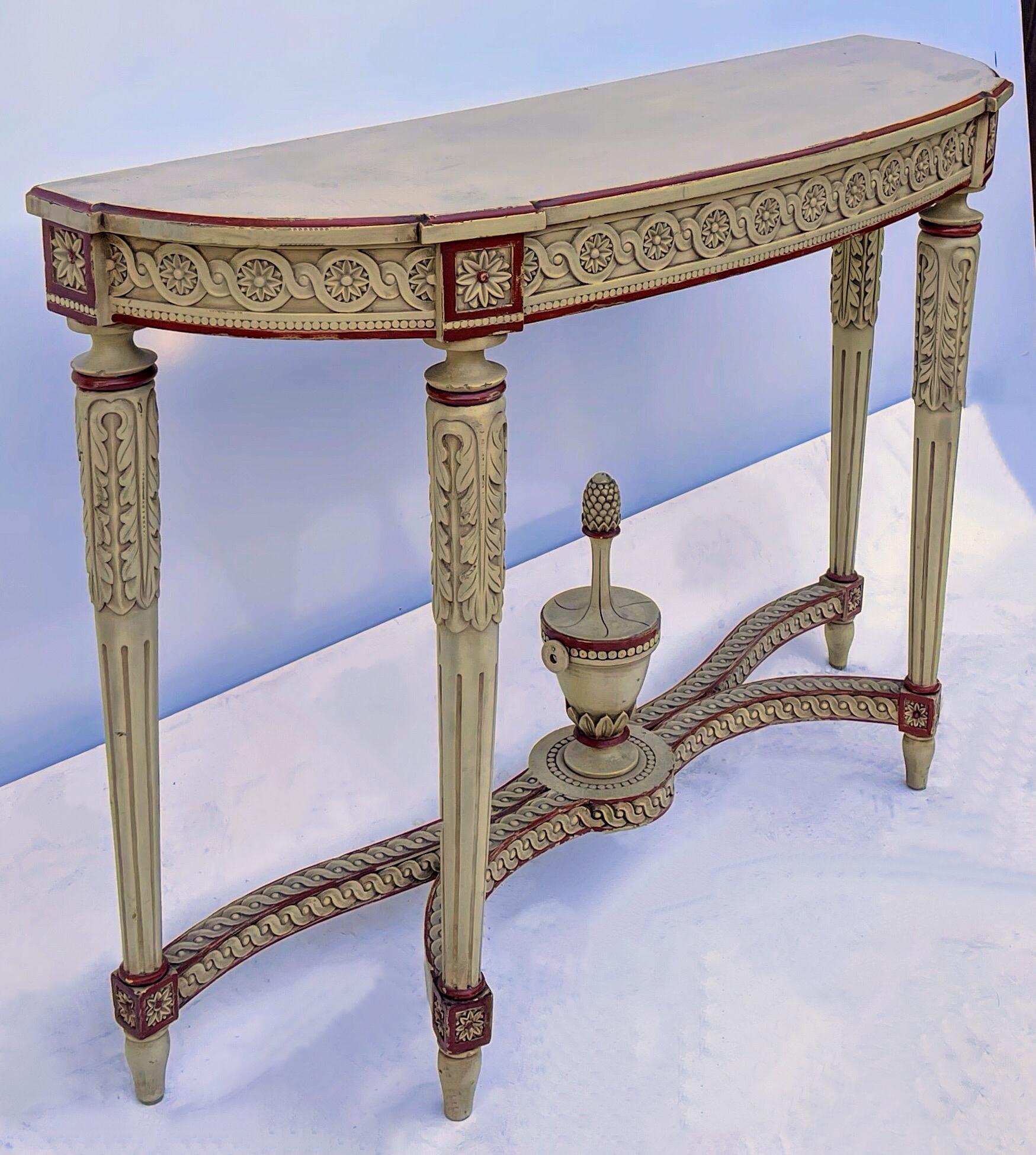 This is an amazing heavily carved regency Maison Jansen style painted console table. Look at that cross stretcher! The ivory and red painted really makes a statement! It is unmarked.