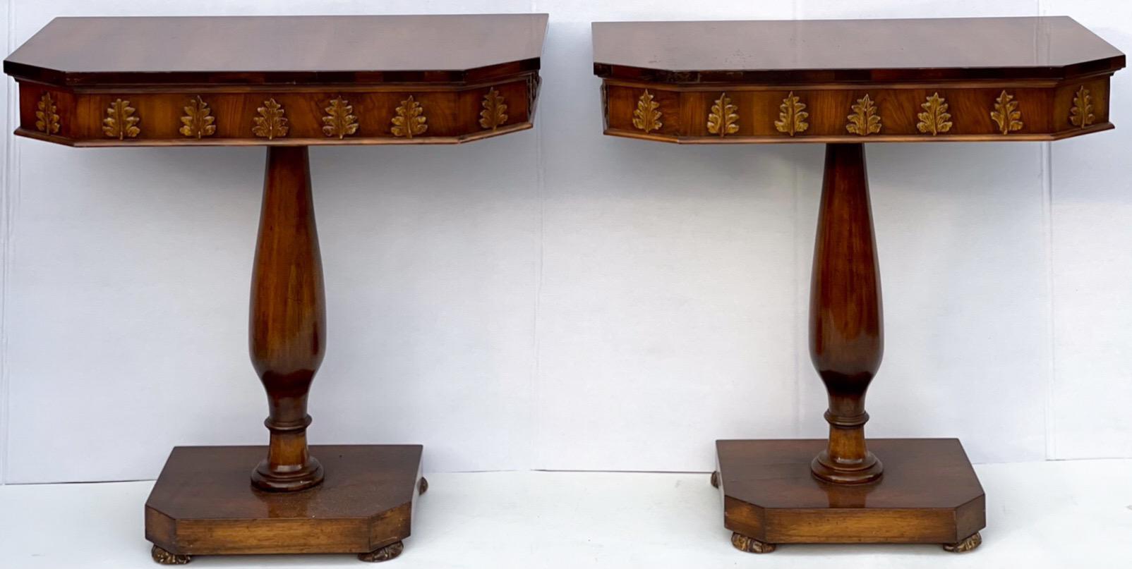 This is a lovely pair of Regency style carved walnut and gilt console tables. The aprons have carved acanthus leaves. The bun feet are nicely carved as well. Nice versatile size!