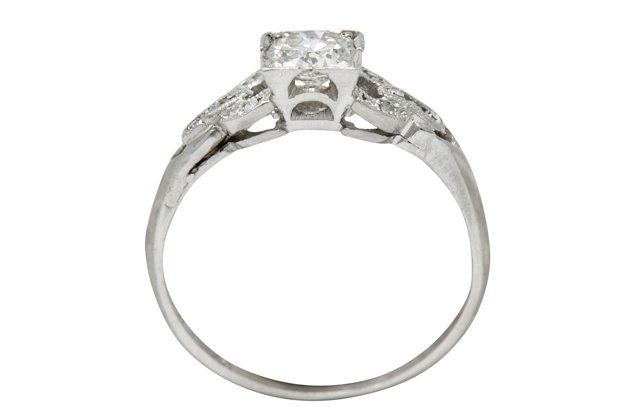 Centering a transitional cut diamond weighing approximately 0.35 carat - I color with SI clarity

Set in a square form and head and is flanked by buckle motif shoulders

Accented by single cut diamonds weighing in total approximately 0.18 carat -