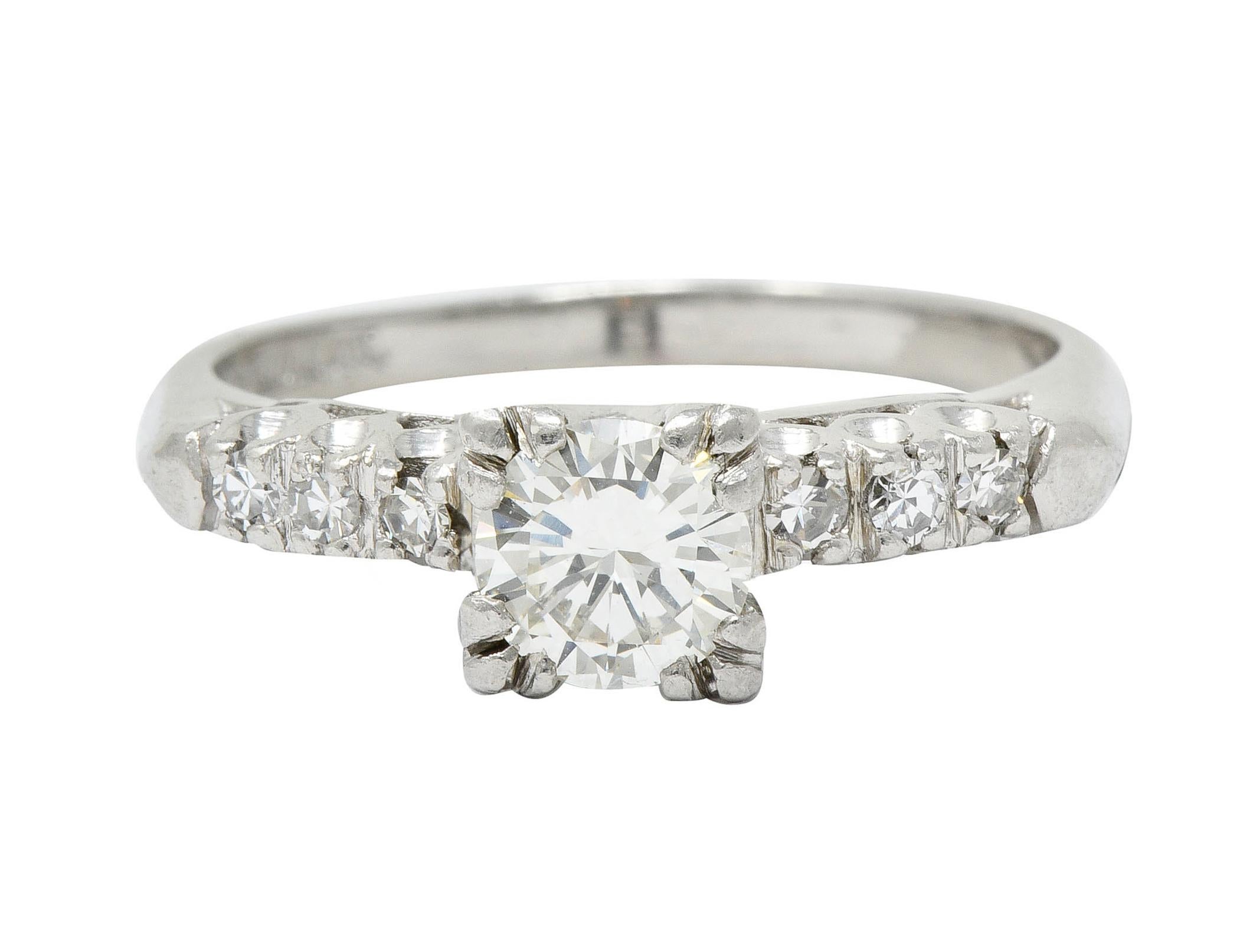 Centering a transitional cut diamond weighing approximately 0.60 carat; I color with VS clarity

Set with tri-bead prongs in a stylized basket and flanked by fishtail motif shoulders

Set with single cut diamonds weighing in total approximately 0.18