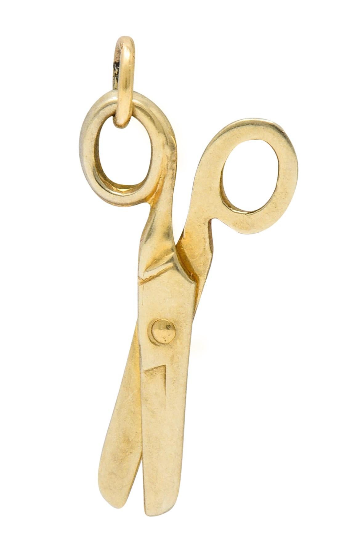 Designed as a pair of gold scissors

That pivot open and closed

Completed by a jump ring bale

Stamped 10K for 10 karat gold

Circa: 1940s

Measures: 7/16 x 13/16 inch

Total weight: 1.0 gram

Functional. Sewing. Shears.
 

Stock  Number: We-6005