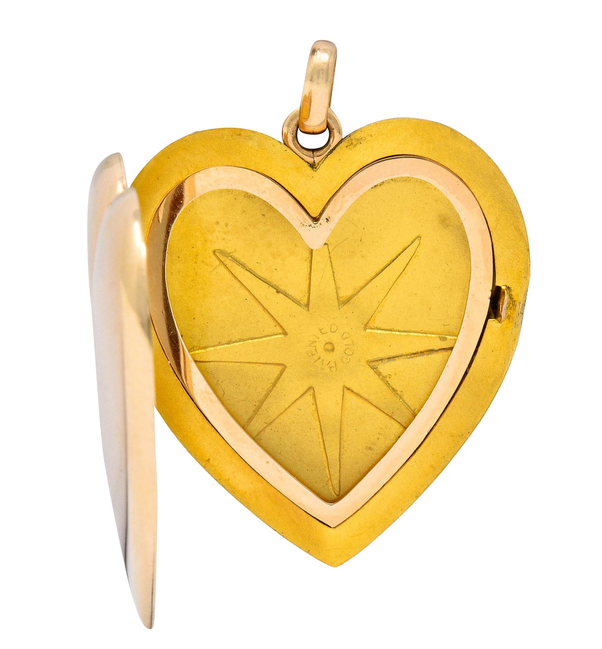 Designed as a substantially sized and brightly polished heart

Opens on a hinge to reveal two recessed areas with removable plastic covers

Completed by a jump ring bale

Tested as 10 karat gold

Circa: 1940s

Measures: 1 3/16 x 1 1/2 inches

Total