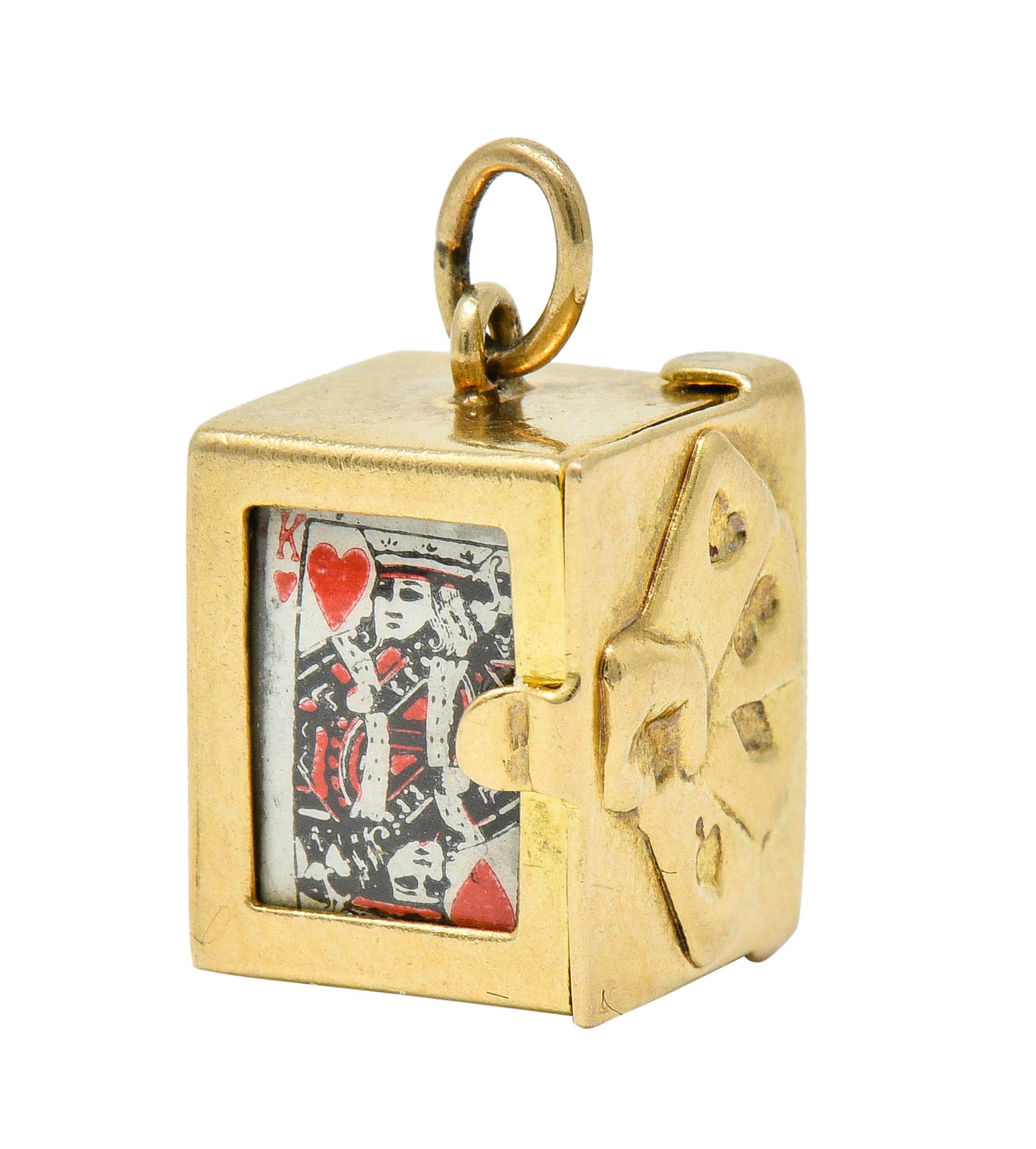 Charm is designed as a rectangular gold box

Lid features a repoussè card motif and opens on a hinge to reveal a stack of miniature cards

Box is pierced in front to show King of Hearts card

Stamped 14K for 14 karat gold

Circa: 1940s

Measures: