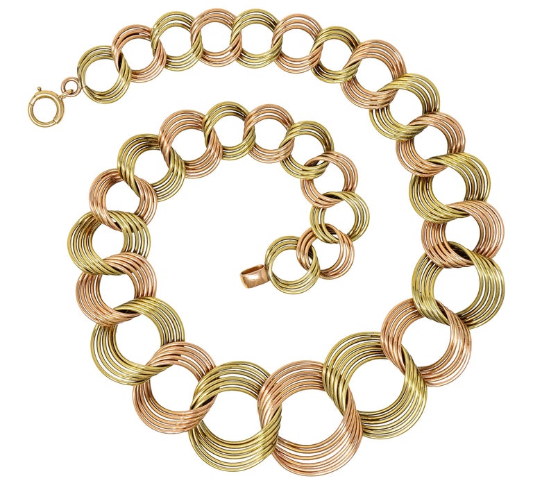 Collar necklace is comprised of rose gold links alternating with green gold

Graduating in size and designed as twisted multi-wire circles

Ranging from 32.0 mm to 16.5 mm

Completed with spring clasp closure

Stamped 14K for 14 karat gold

Maker's