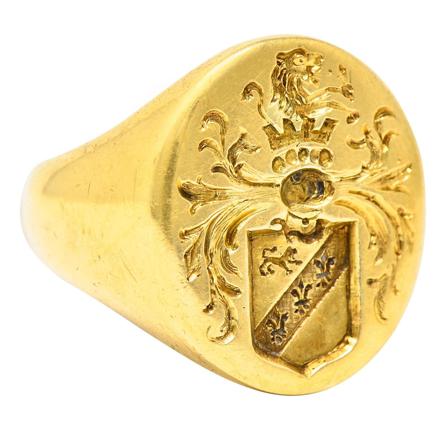Signet style ring with an oval face

Deeply engraved to depict a shield with lion and surrounded by whiplash

Topped by a standing roaring lion and crown motif

Marked 14k for 14 karat gold and with inner inscription

Circa: 1940

Ring Size: 6