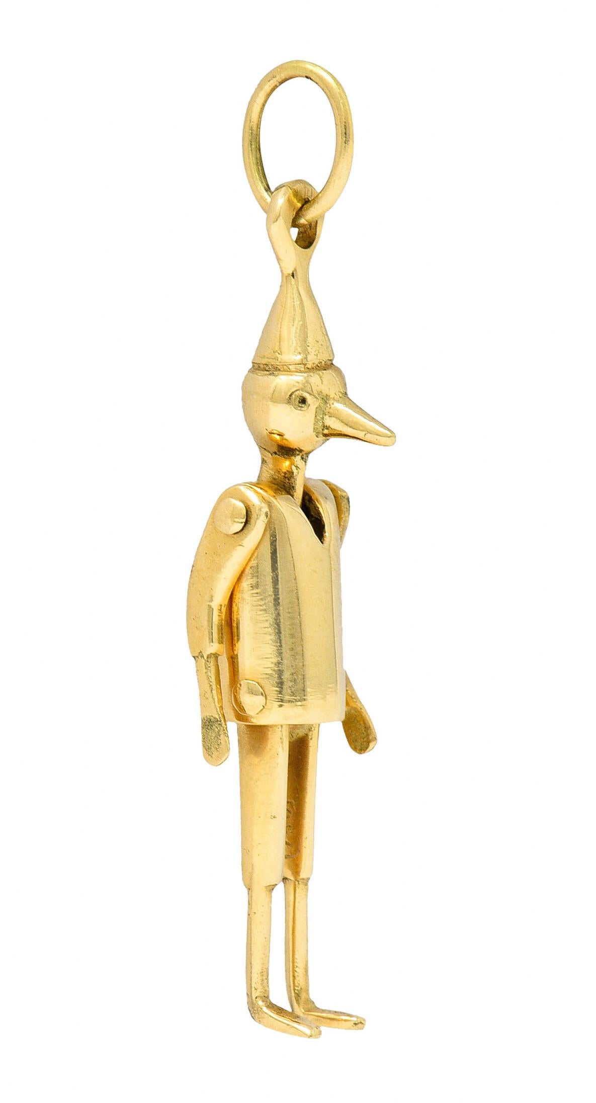 Charm is designed as Pinocchio with a polished gold finish

With articulated arms and legs then topped by jump ring bale

Stamped 750 for 18 karat gold

Circa: 1940s

Measures: 5/16 x 1 5/8 inches

Total weight: 4.3 grams

Whimsical. Joyful.