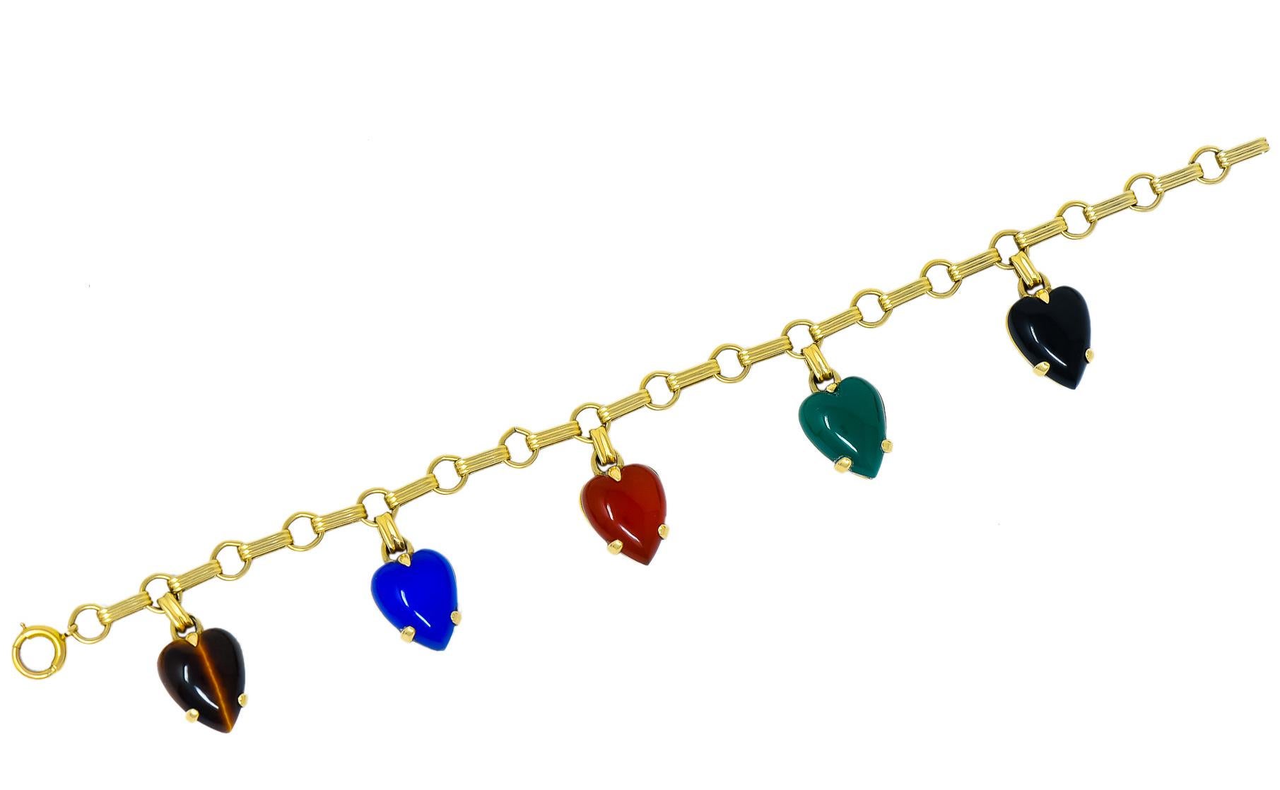 Bracelet designed with ribbed elongated links and round spacer links

With carved heart drops measuring approximately 11.4 x 10.2 mm (slight variation from heart to heart)

Tiger's eye, dyed blue chalcedony, carnelian, chrysoprase, and onyx, opaque