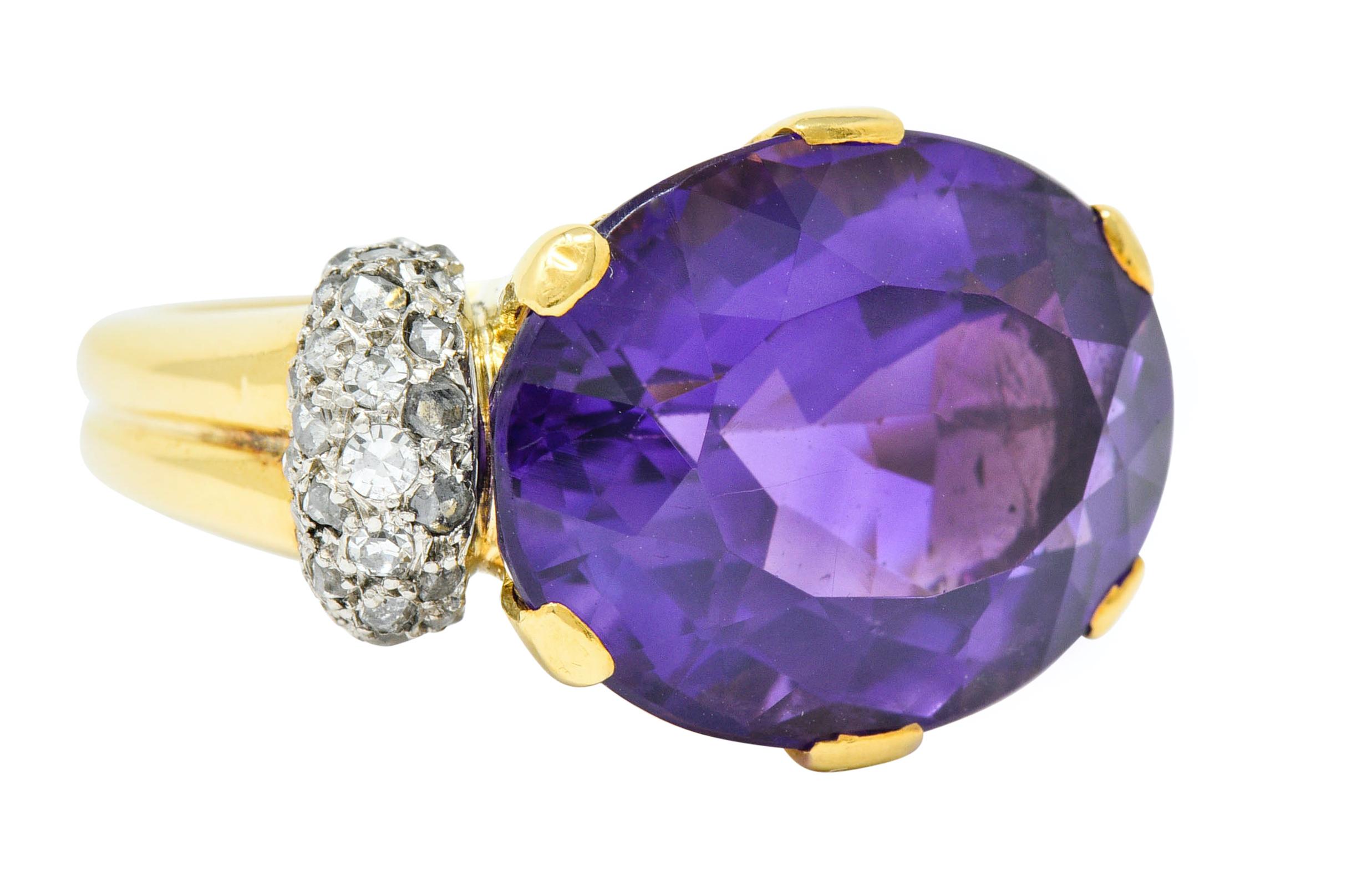 Centering a large oval cut amethyst, set East to West by six wide prongs

Vibrant purple in color and measures 18.2 x 13.8 mm

Flanked by platinum shoulders accented by rose cut diamonds

Weighing in total approximately 1.00 carat; varied in color