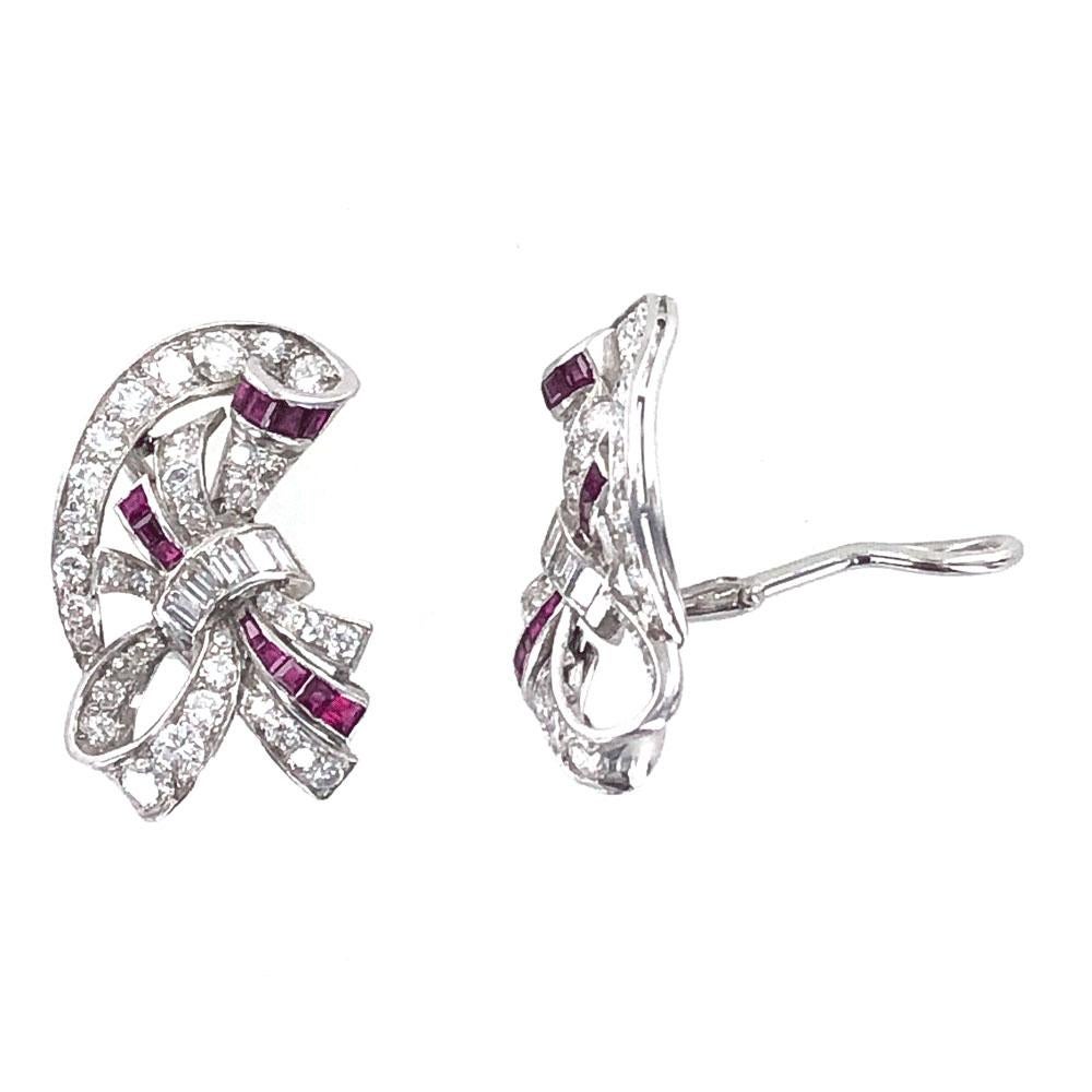 Beautifully crafted diamond and ruby earrings circa 1940's. The earrings are fashioned in platinum and feature 4.00 carat total weight of white round brilliant cut and baguette cut diamonds. The bright diamonds are graded G-H color and SI1 clarity. 