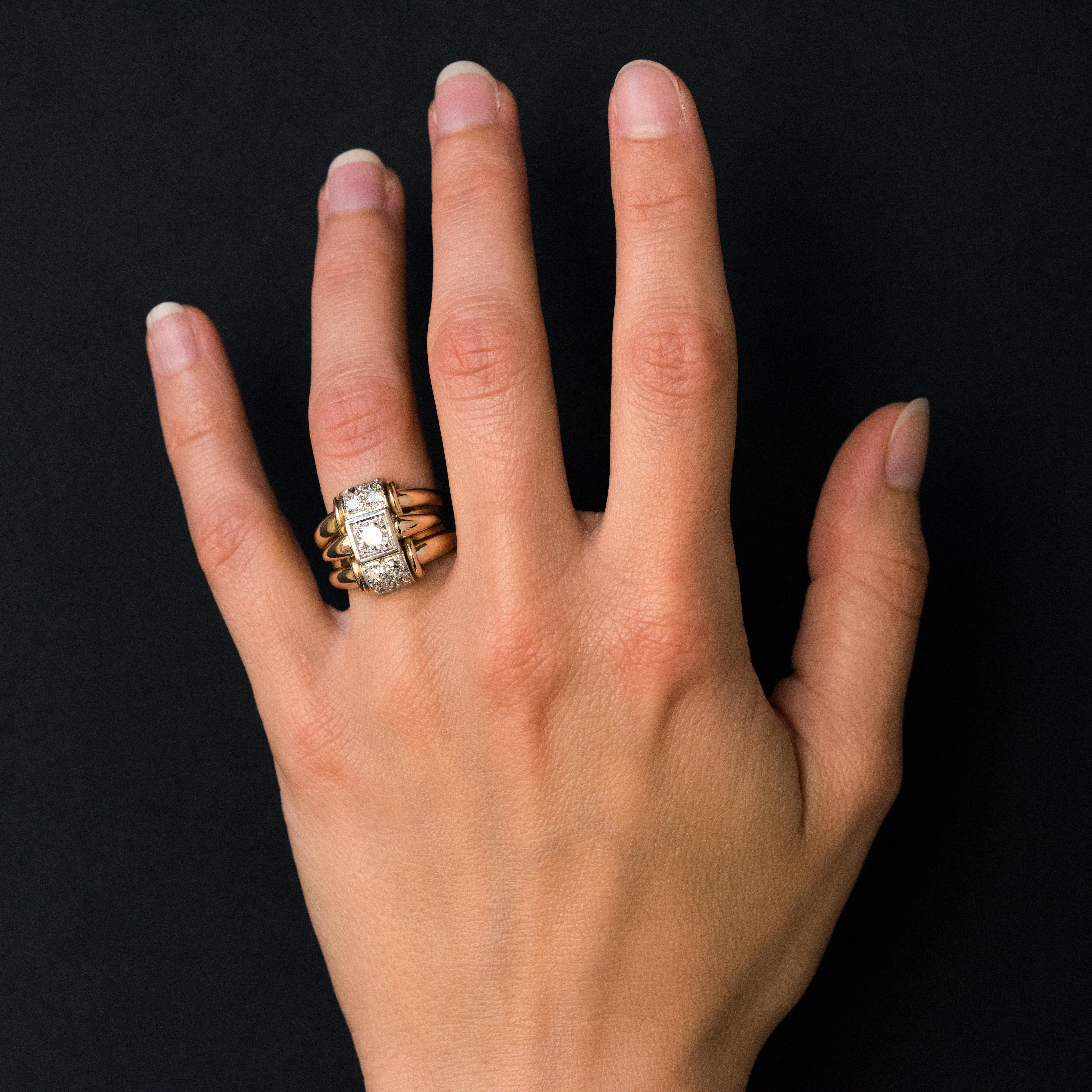 Ring in 18 karats yellow gold, and platinum.
With an ideal size, the top of this tank ring consists of 3 rings including the center one, raised, is adorned with an antique- brilliant- cut diamond. The other two rings are each set with 4 antique-