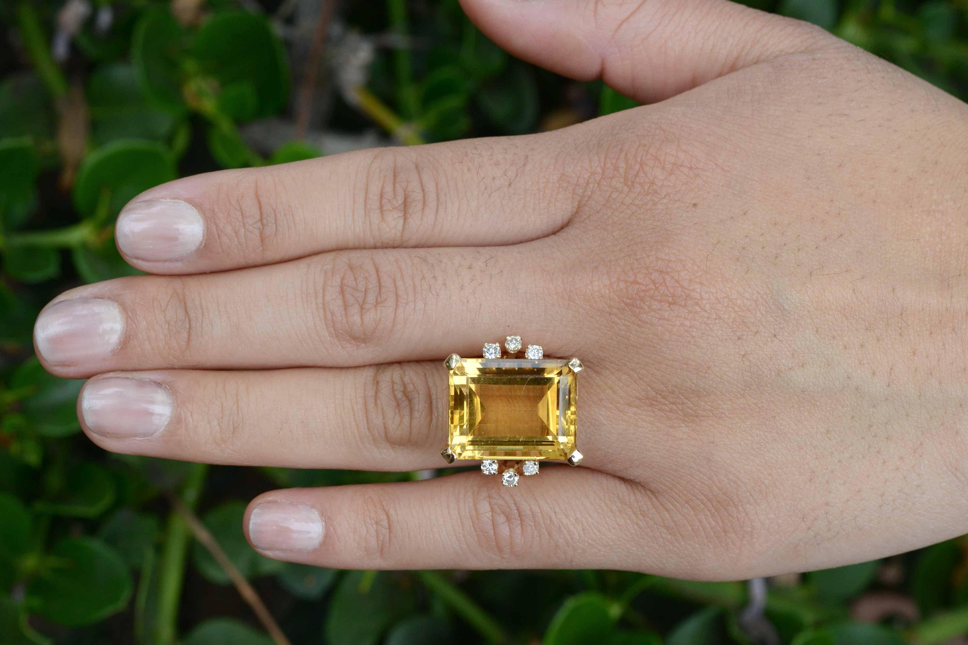 Centered by a rare, juicy and colossal 19+ carat golden-yellow natural citrine, this original, vintage 1940s Retro cocktail ring makes a bold statement. Regally perched atop a weighty yellow gold cathedral setting and accented by 6 sparkly diamonds.