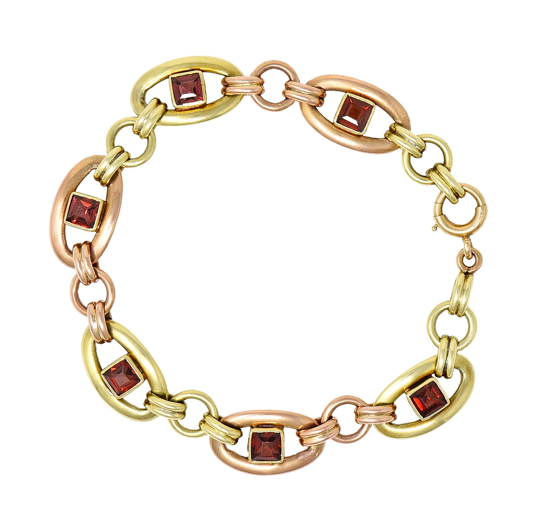 Link bracelet is comprised of oval links - green and rose gold alternating. With ribbed and circular spacer links. Featuring bezel set square cut garnets measuring approximately 4.5 x 4.5 mm. Eye clean with orangey red to purplish red color - medium