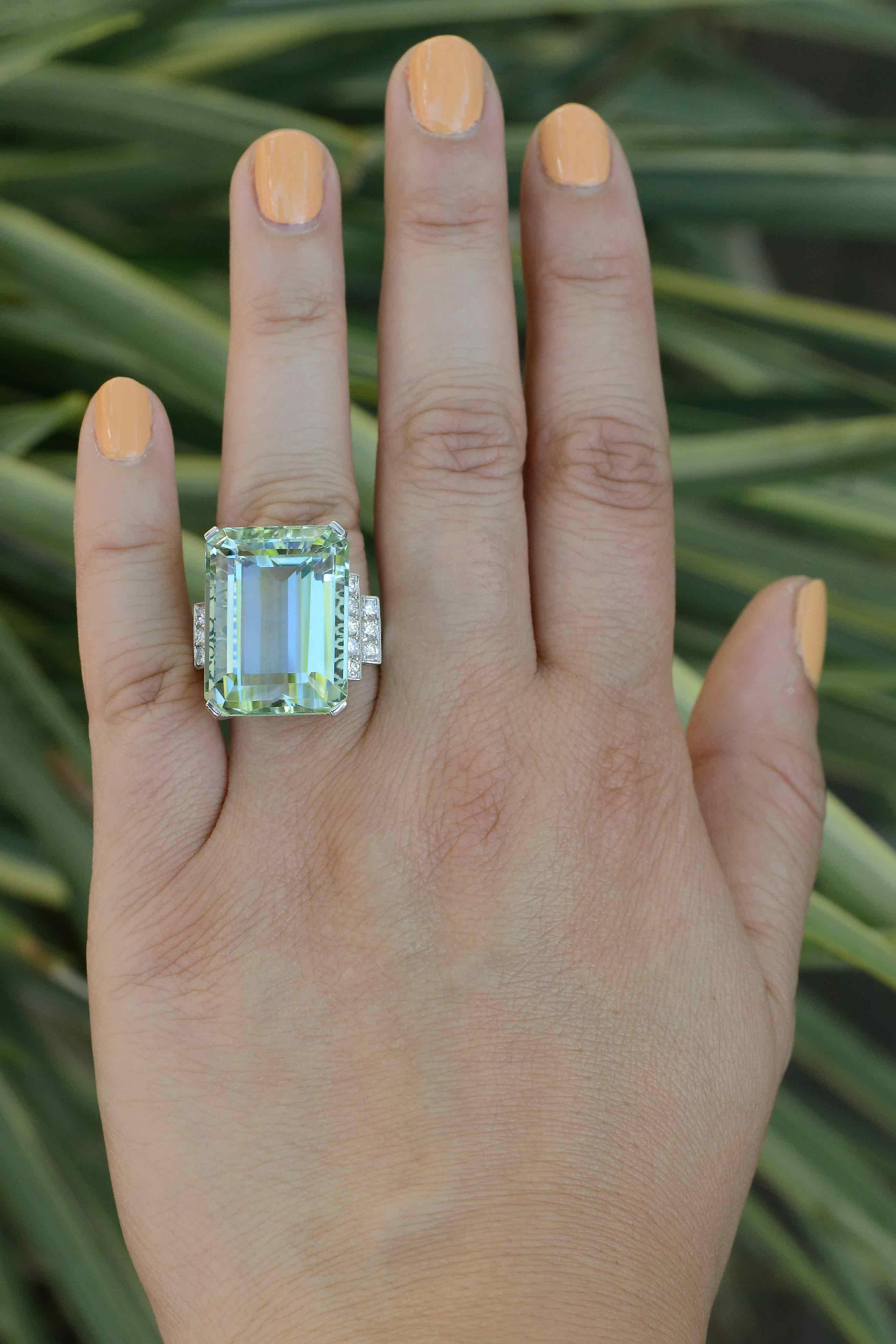 This marvelous 31.53 carat aquamarine platinum cocktail ring is fitted in grand 1940s retro style. A large, intriguing emerald cut gemstone boasting a magnetic greenish blue hue, evoking the mystery of the sea. You will get lost staring into the