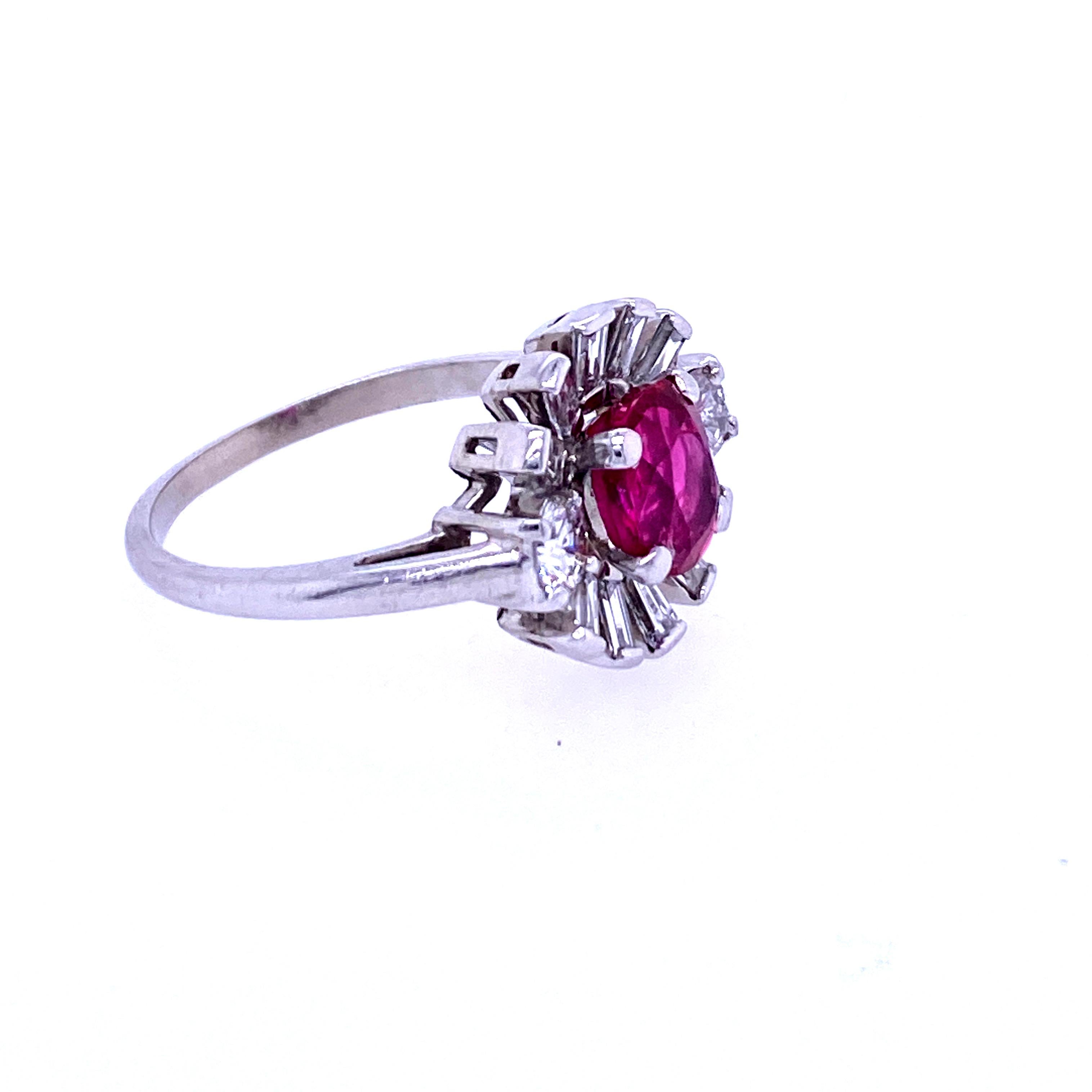 One platinum (stamped PLAT) retro ring, cathedral set with one 7 x 5.3mm oval cut natural ruby.  The ruby is surrounded by ten straight baguette diamonds approximately 0.30 carat total weight  with matching H/I color and VSI/VS2 clarity and two