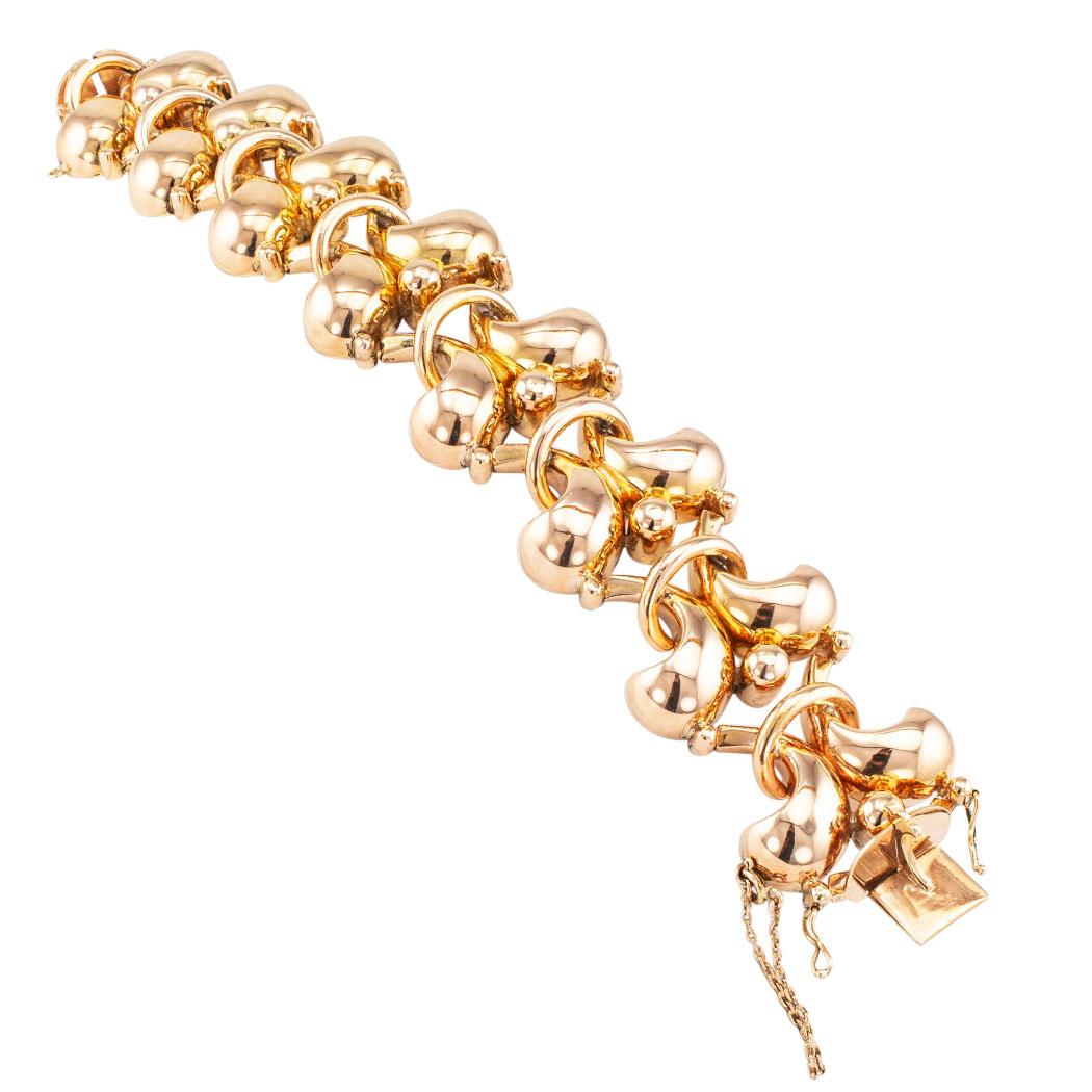 Retro rose gold link bracelet circa 1940. Designed as a series of interlocking geometric and organic, bombé motifs crafted in 18-karat rose gold. We love the chunkiness of this elegant and classy Retro gold bracelet. The shape of the links is hard