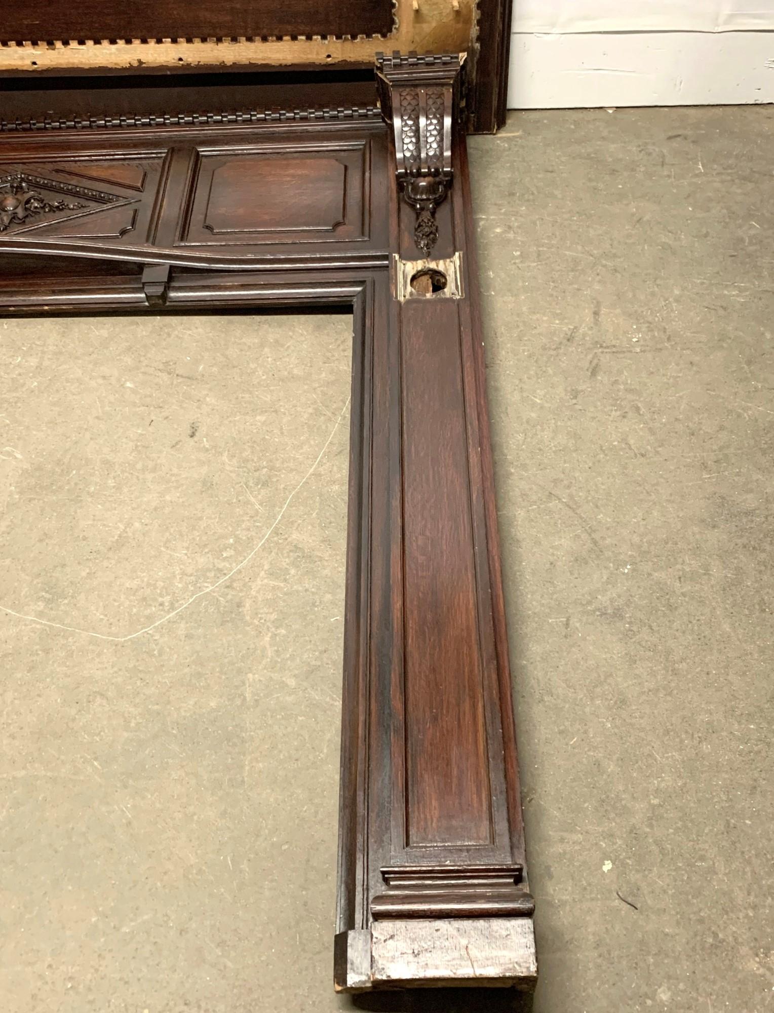 Rococo style mantel made of walnut in a dark finish from the 1940s. This mantel is in salvaged condition. Please review the images to see the current condition. The square metal hooks are not included, but can be replaced with a square metal