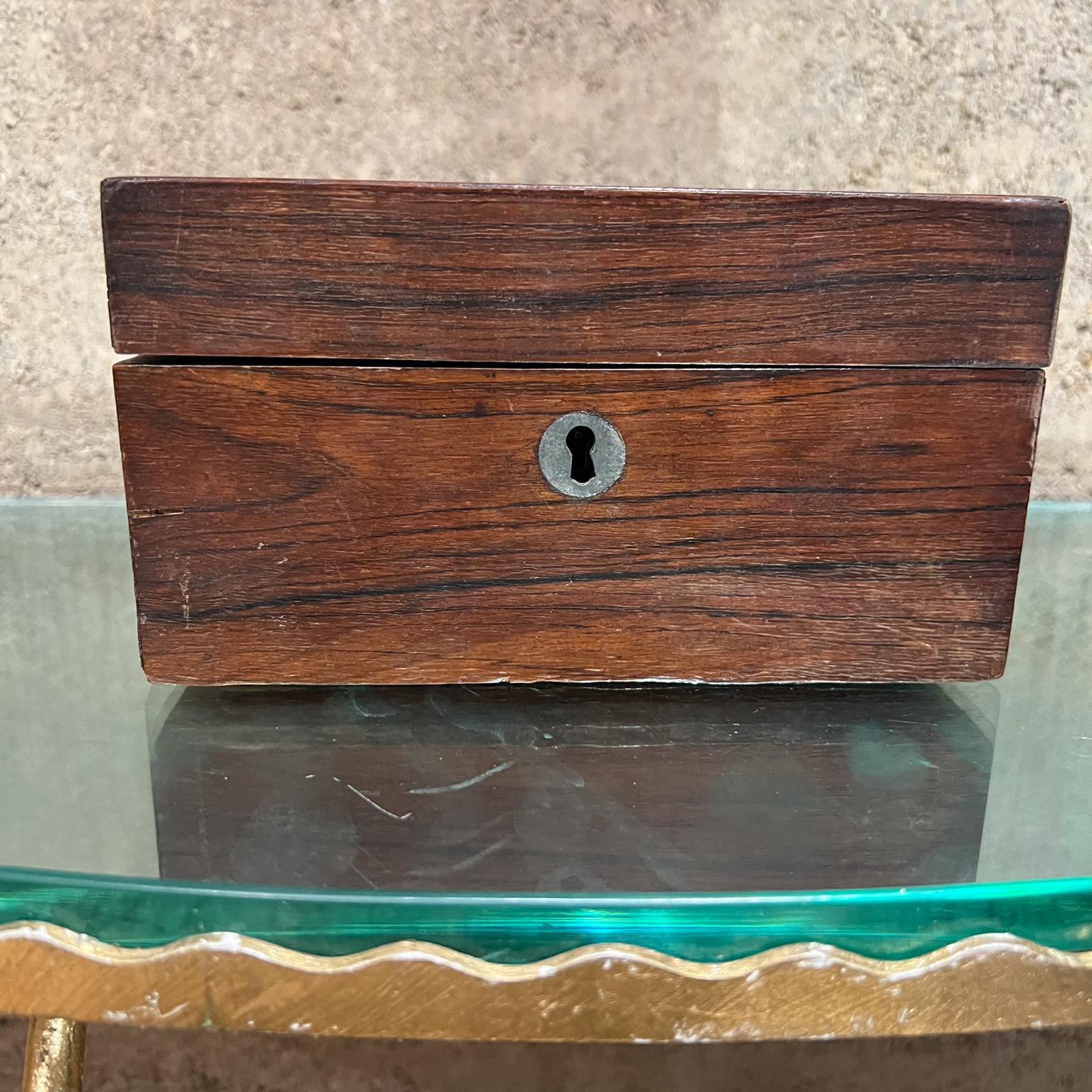 Small Rosewood Box vintage with clean modern lines.
Divided interior 
Rosewood veneer 
Preowned vintage unrestored condition. Some prior repairs are visible. 
No key.
3.75 tall x 7 w x 4.75 d
Refer to images please.