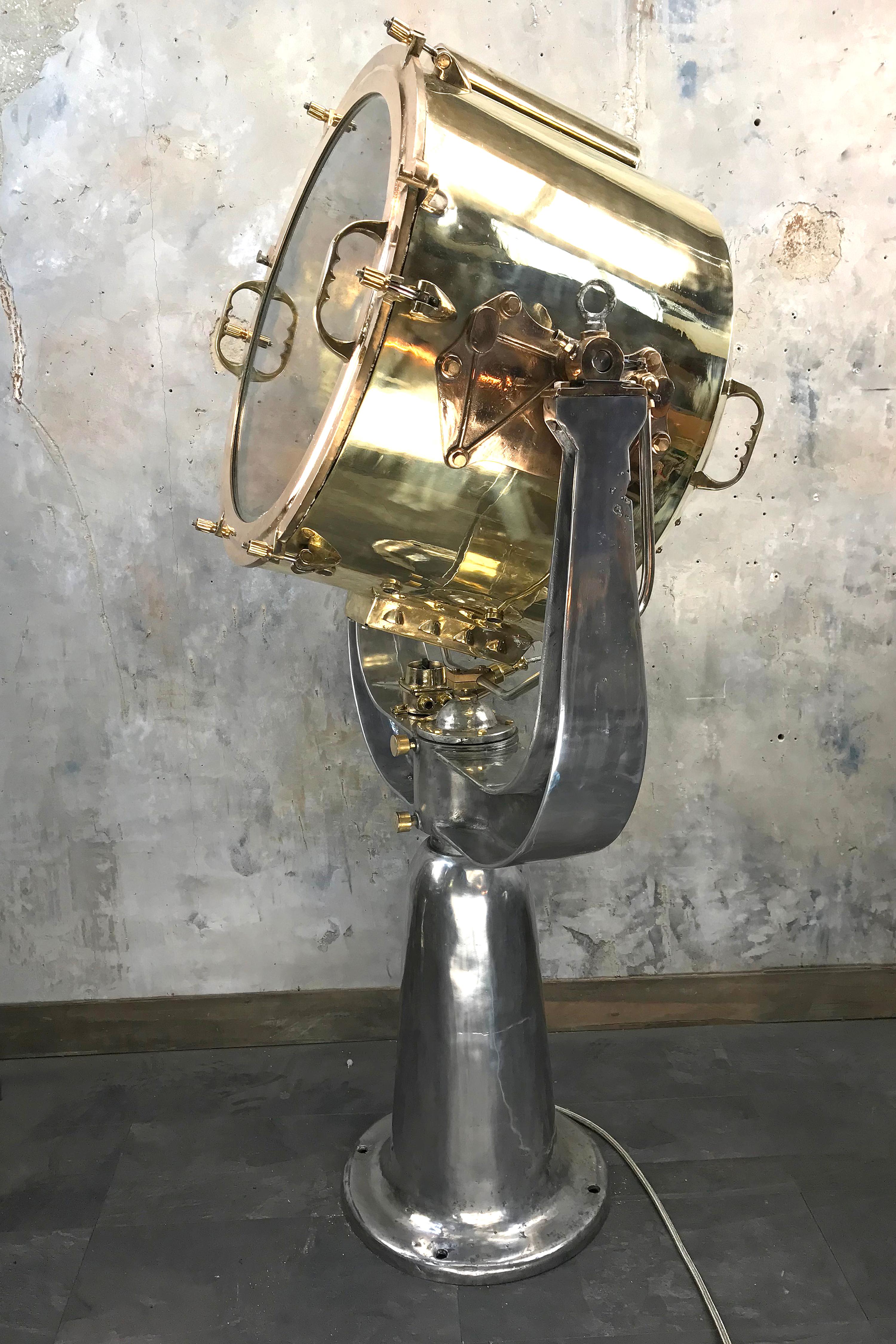 An extremely sought after naval searchlight dating form circa 1940 and made by Rotherham's of Coventry, England.

The base and yolk of the searchlight are cast aluminium, the light is machine made brass, with the glass frame and pivot mounts from