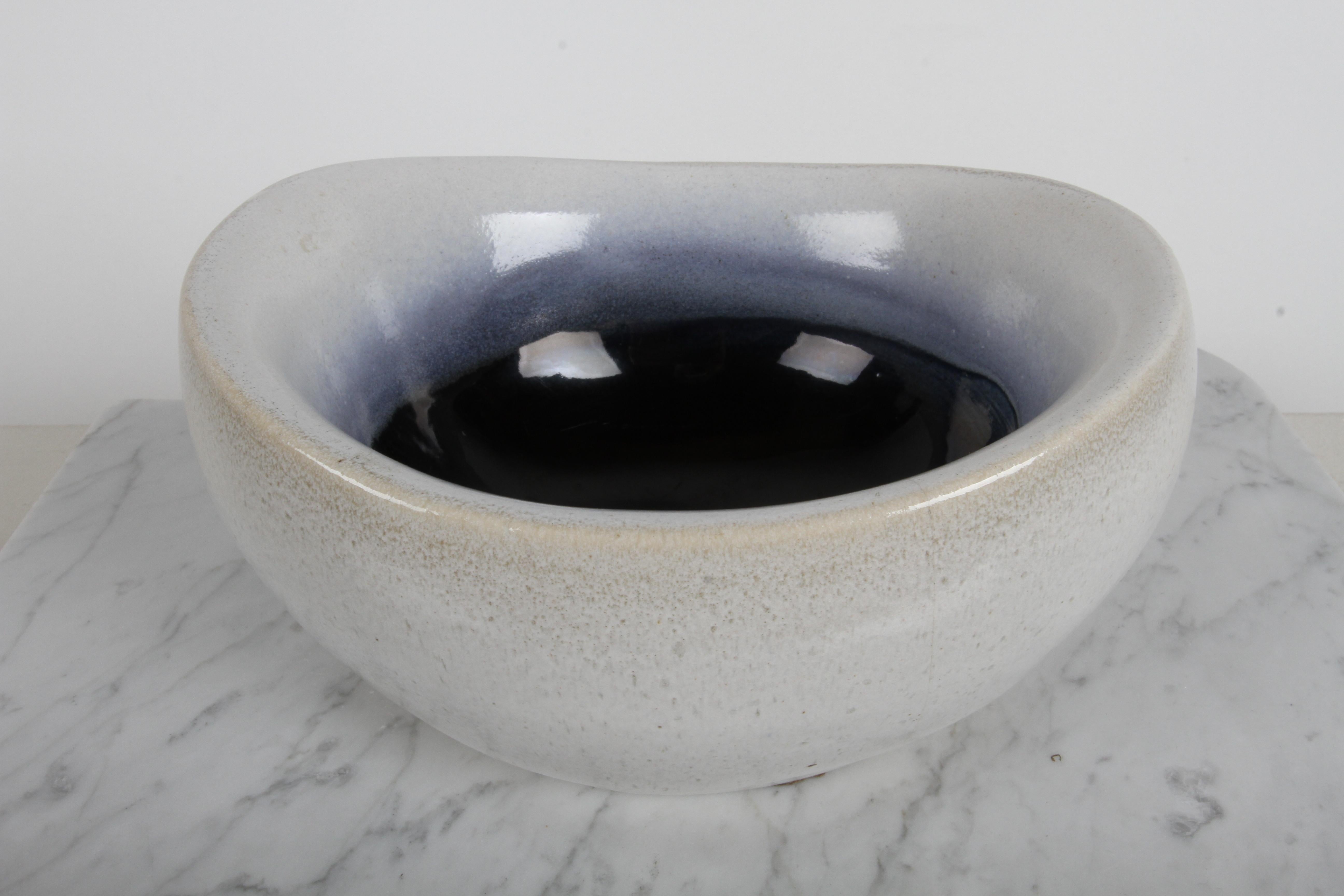 Early and fairly rare vintage Russel Wright for Bauer Pottery large ans heavy oval bowl with light gray exterior with fading to dark blue interior color.  Russel designed decorative objects to be manufactured at Bauer Pottery in Atlanta, Georgia.