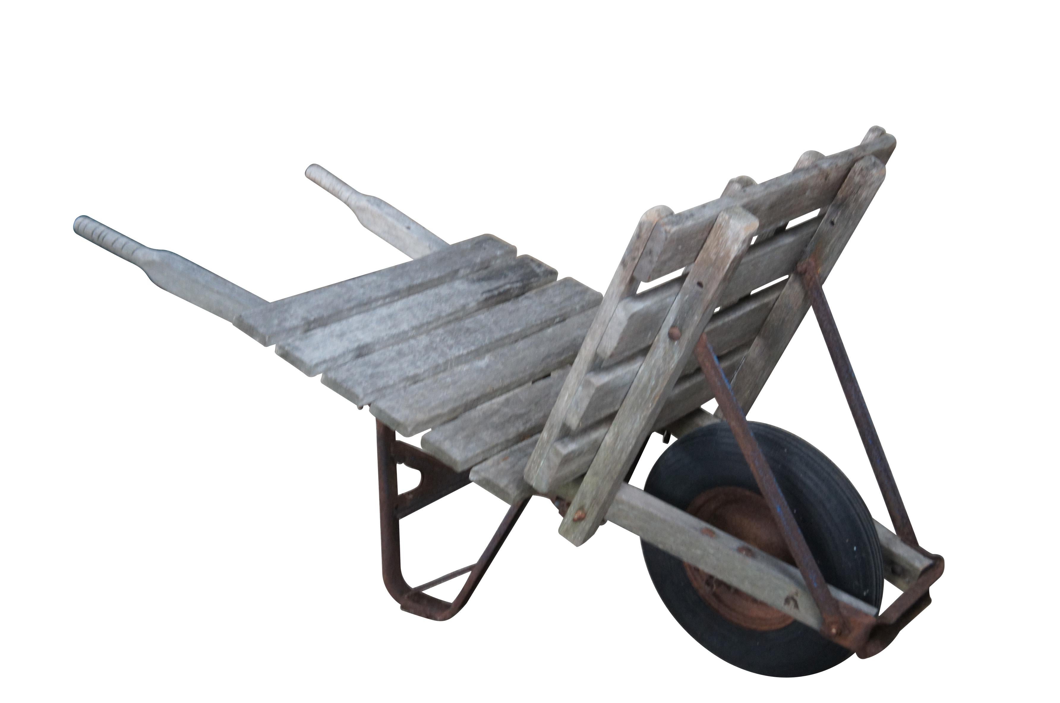 1940s Flat-bed wheel barrow.  Intended for bricks or hay.  Features a wooden frame on wheel with metal support.  

Dimensions:
61
